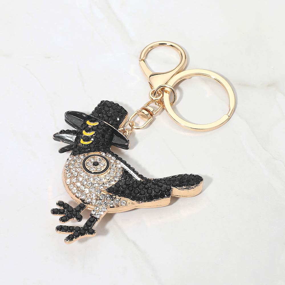 Bling studded Kpop Demon Hunters Sussie keychain bag charm with shiny embellishments, attached to a black bag or wallet.
