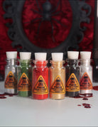 Makeup A Murder, INC Holiday Poison Pigment Collection with vibrant, colorful eyeshadows in festive packaging.