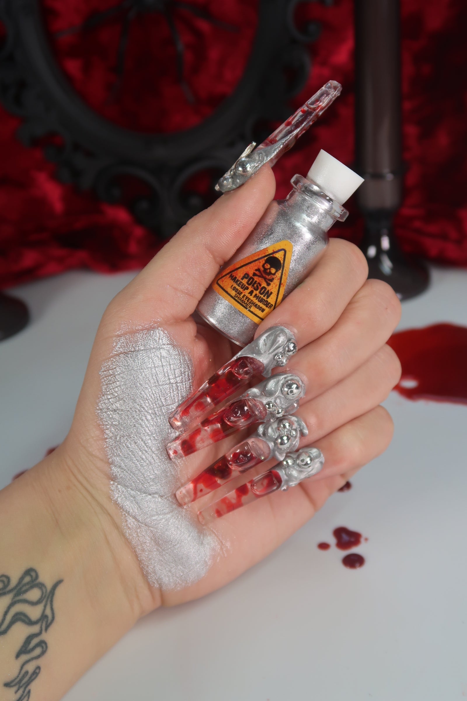 Colorful swatches from Makeup A Murder, INC's Holiday Poison Pigment Collection showcasing vibrant makeup pigments.
