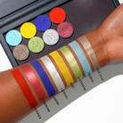 Eyeshadow lineup by Makeup A Murder, INC featuring various shades of eye shadow in a colorful palette display.
