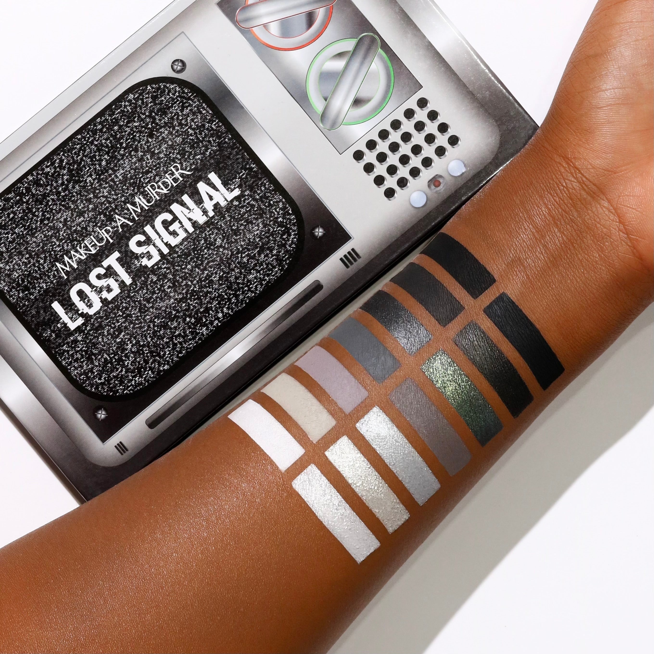 Makeup A Murder, INC Lost Signal Eyeshadow Palette with vibrant and neutral shades in a sleek rectangular case.