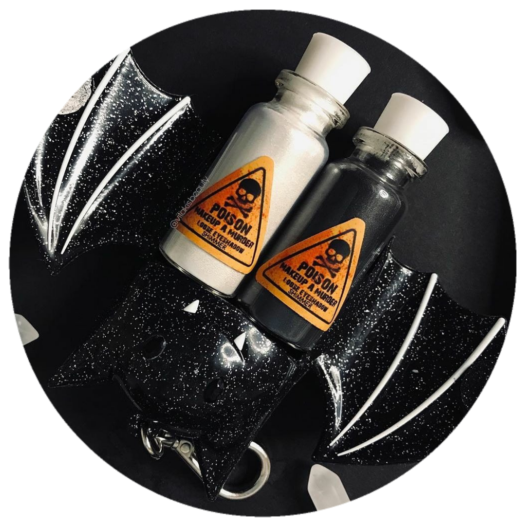 Makeup A Murder, INC Poison Pigment Collection shimmer mustard gas master pigment in a container with a metallic finish.