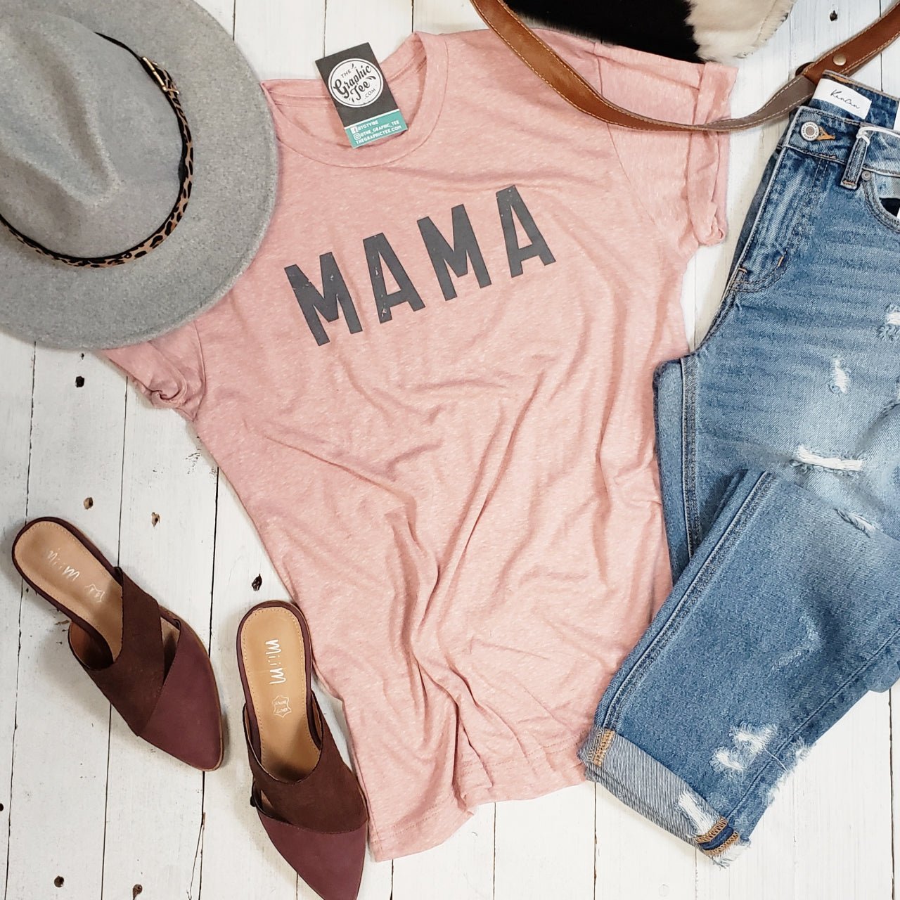 Unisex short sleeve graphic tee by The Graphic Tee featuring a stylish Mama design on a soft fabric shirt.