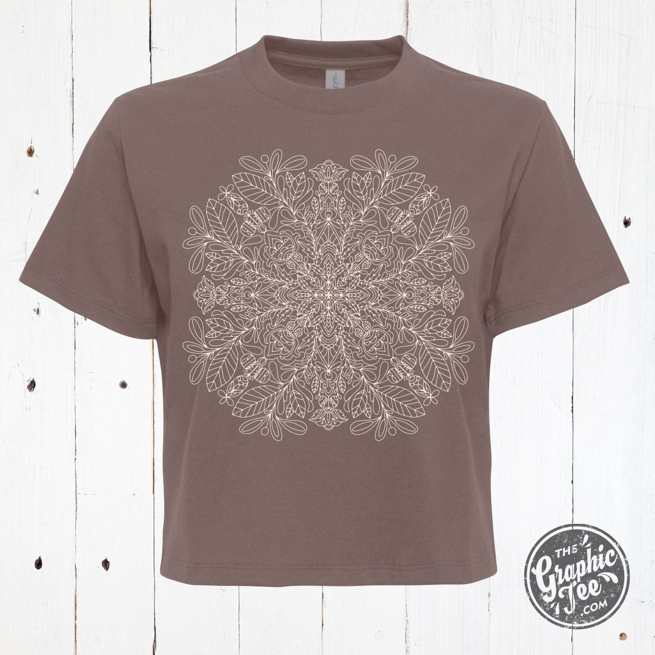 Mandala design women's waist-length short sleeve tee by The Graphic Tee, showing vibrant print on lightweight shirt.