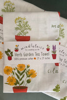 Herb Garden Tea Towel by Mindfulnice featuring a botanical herb print, perfect for kitchen decor and gift-giving.