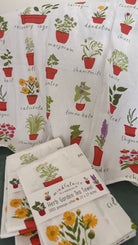 Herb Garden Tea Towel by Mindfulnice featuring botanical herb illustrations on a white kitchen towel.