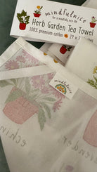 Herb Garden Tea Towel by Mindfulnice featuring botanical herb illustrations, ideal for kitchen decor or gift use.