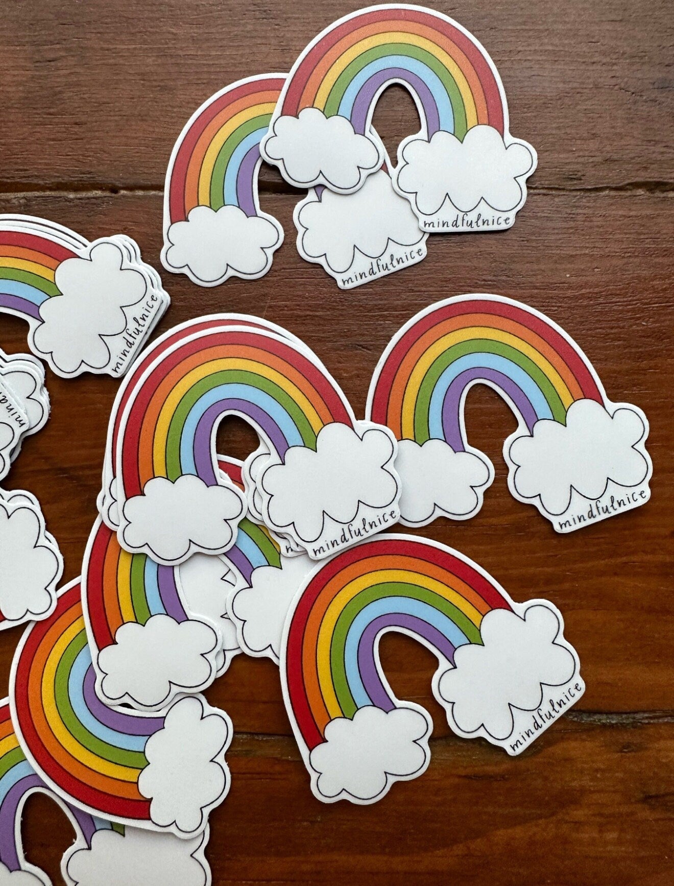 Colorful rainbow sticker from Mindfulnice featuring vibrant, curved stripes perfect for decorating notebooks and laptops.
