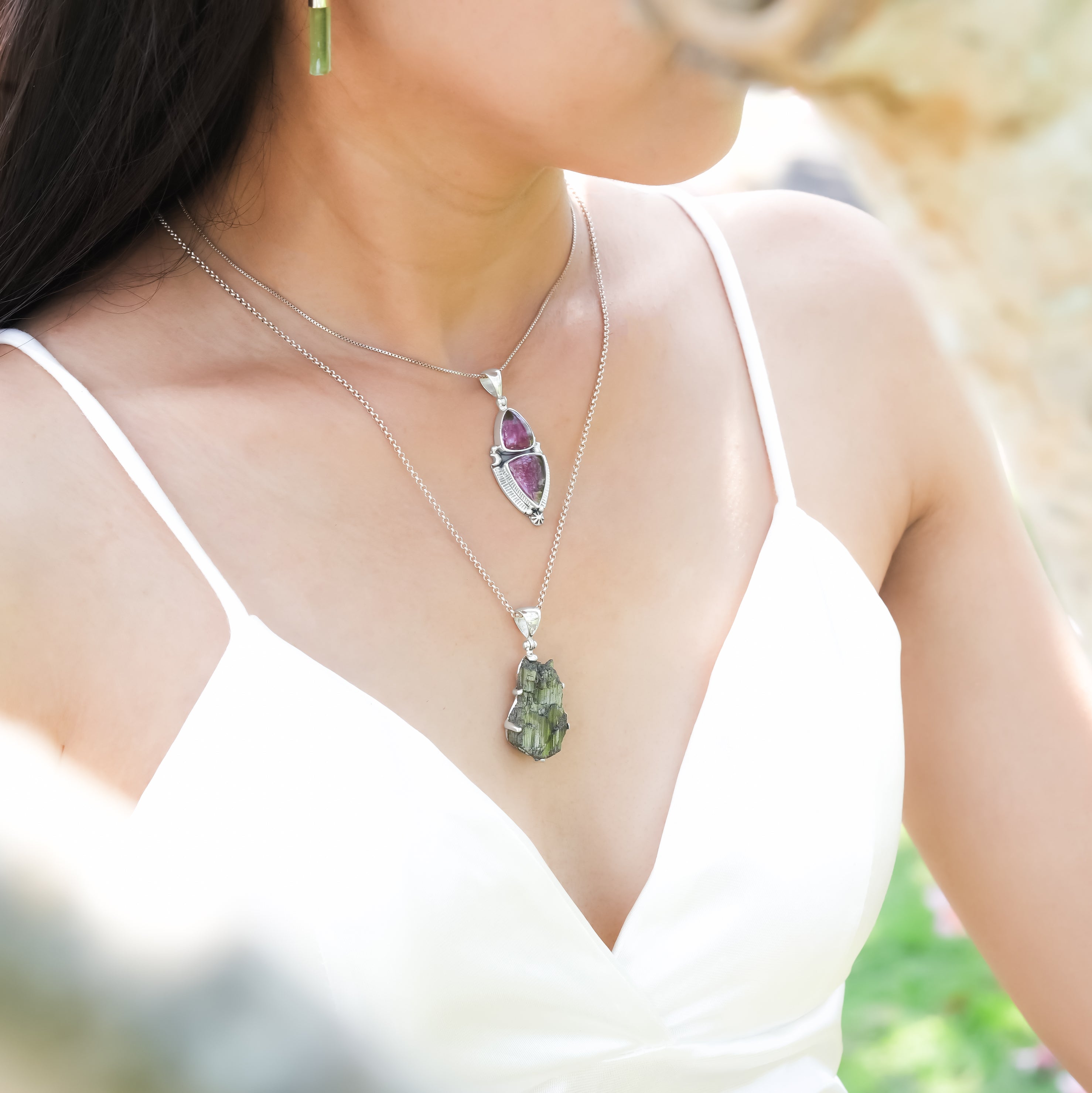 Starborn Creations natural tourmaline crystal pendant in sterling silver, worn by a model, showcasing its vibrant gemstone and sleek design.