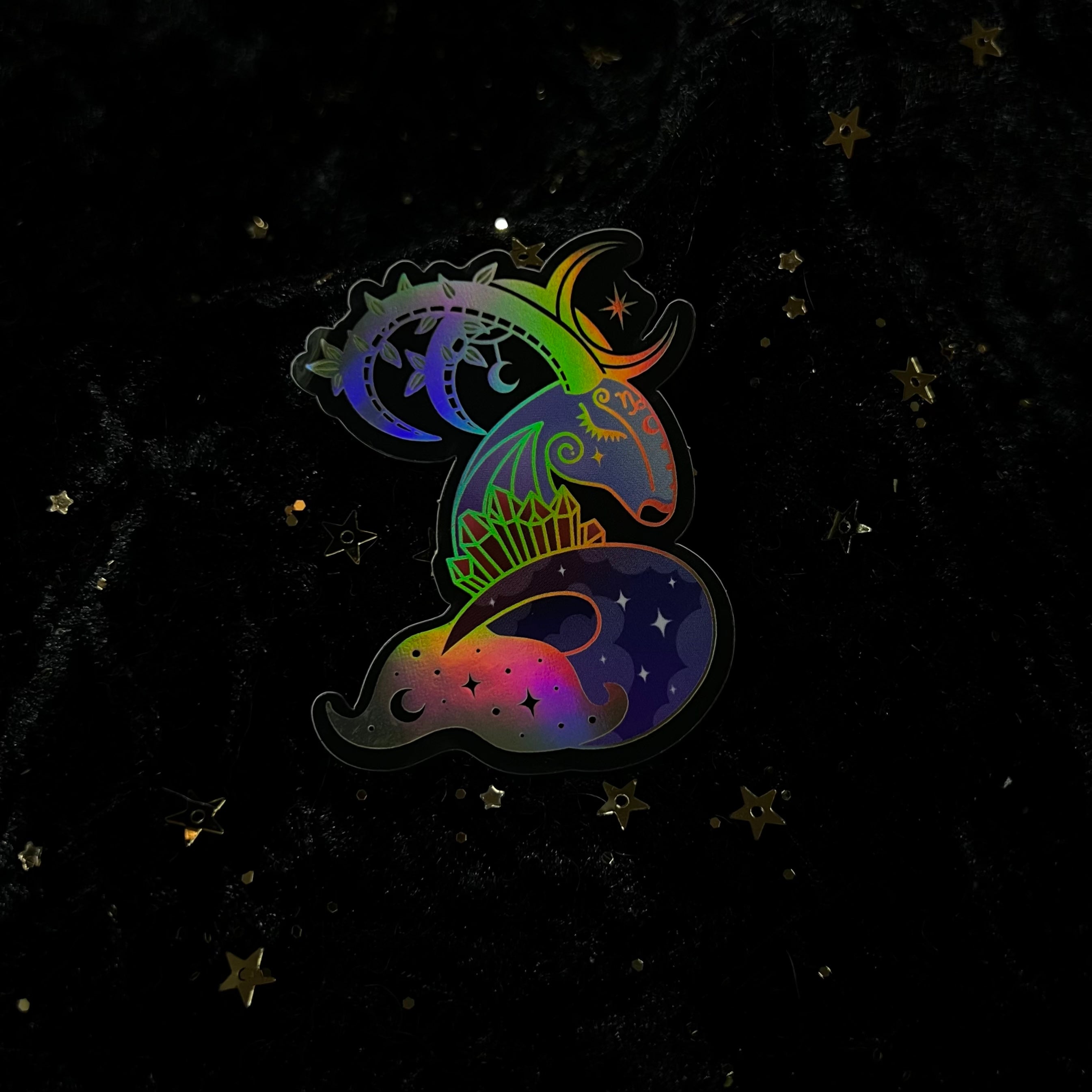 Colorful zodiac crystals sticker by Moonstruck Crystals featuring celestial designs and zodiac symbols on a vibrant background.
