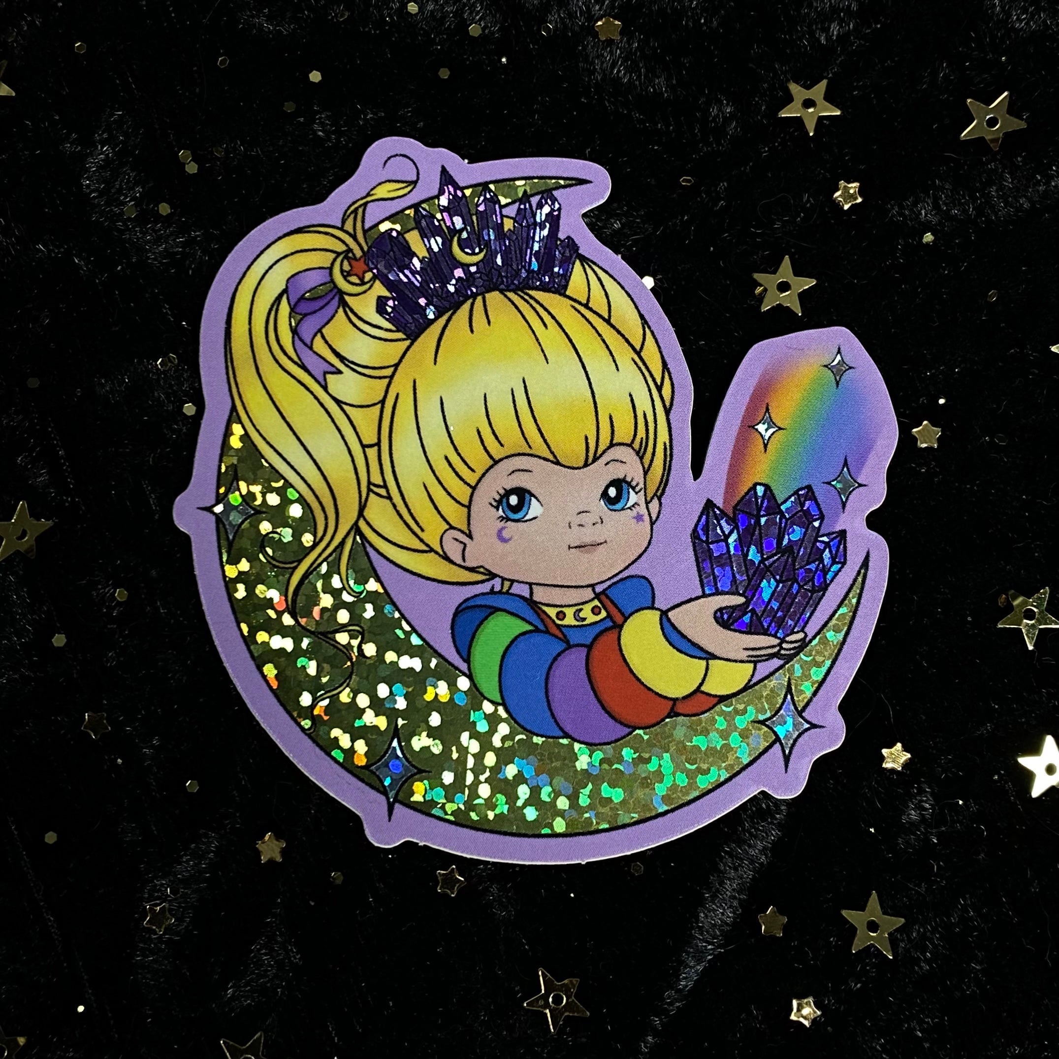 Rainbow Brite-inspired glitter crystal sticker featuring vibrant rainbow colors and shimmering details from Moonstruck Crystals.