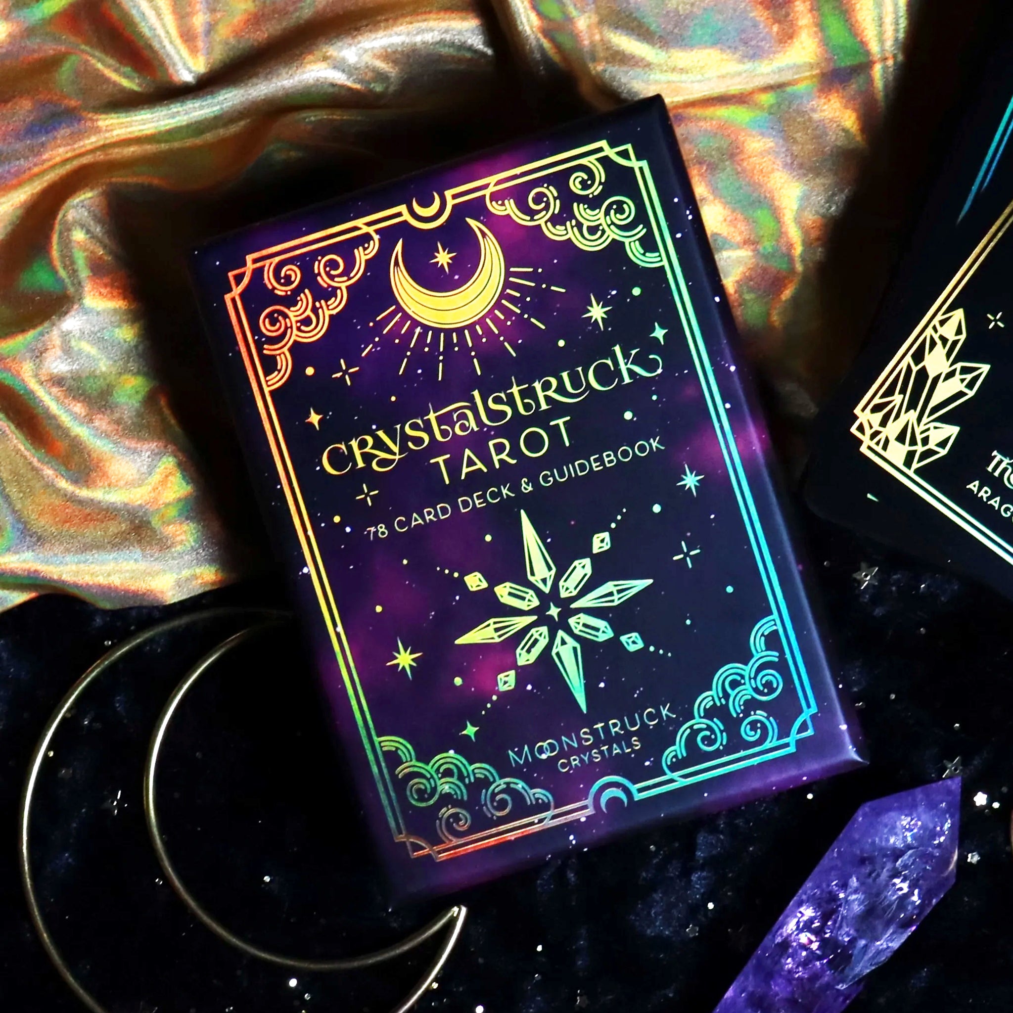 Gold Crystalstruck Tarot© card deck by Moonstruck Crystals, featuring intricate crystal-inspired designs on the cards.