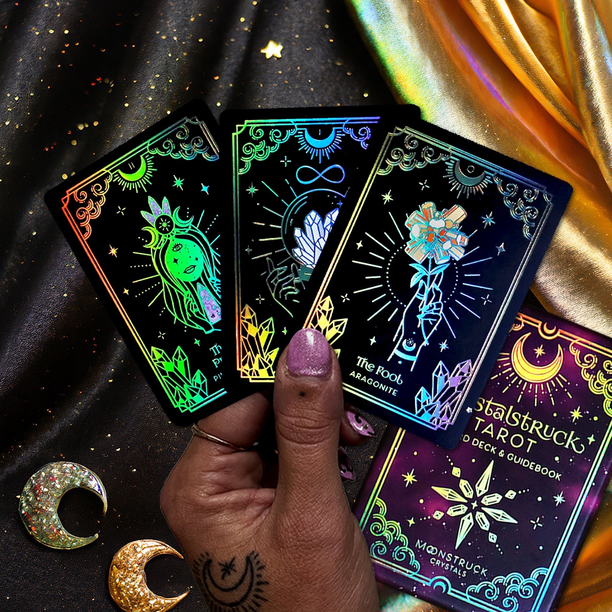 Mini Gold Crystalstruck Tarot© Card Deck by Moonstruck Crystals, showing a close-up of the intricately designed tarot cards with gold accents.