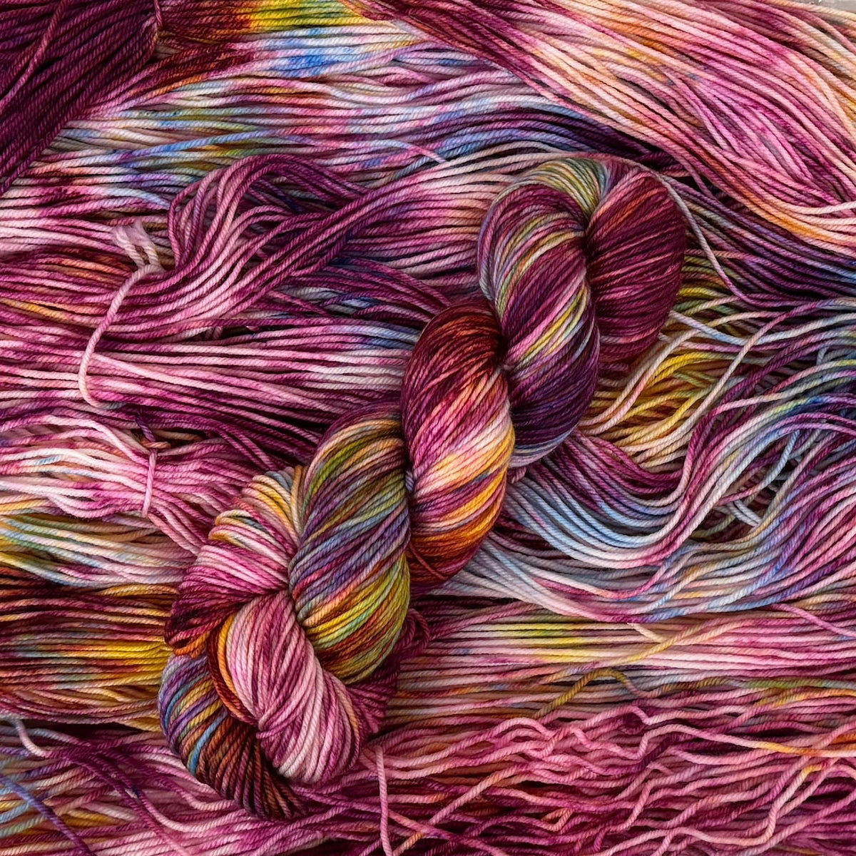 Mountaintop Yarn Glass Gem Corn yarn in vibrant, multicolored skein showcasing its bright, jewel-toned fiber texture.
