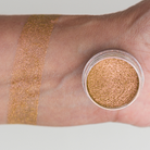 Shimmering cosmic pigment by NABA Cosmetics USA showcasing vibrant, iridescent glittery makeup in a close-up shot.