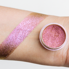 Bright pink Pixie Pigment from NABA Cosmetics USA in a clear jar, showcasing vibrant, shimmering cosmetic pigment for eye and face makeup.