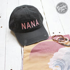 Nana charcoal distressed canvas cap by The Graphic Tee with a curved brim and casual style.