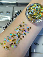 Nekoyanin Gel Glitter Tears in a small jar with shimmering gold glitter and a brush applicator on a white background.