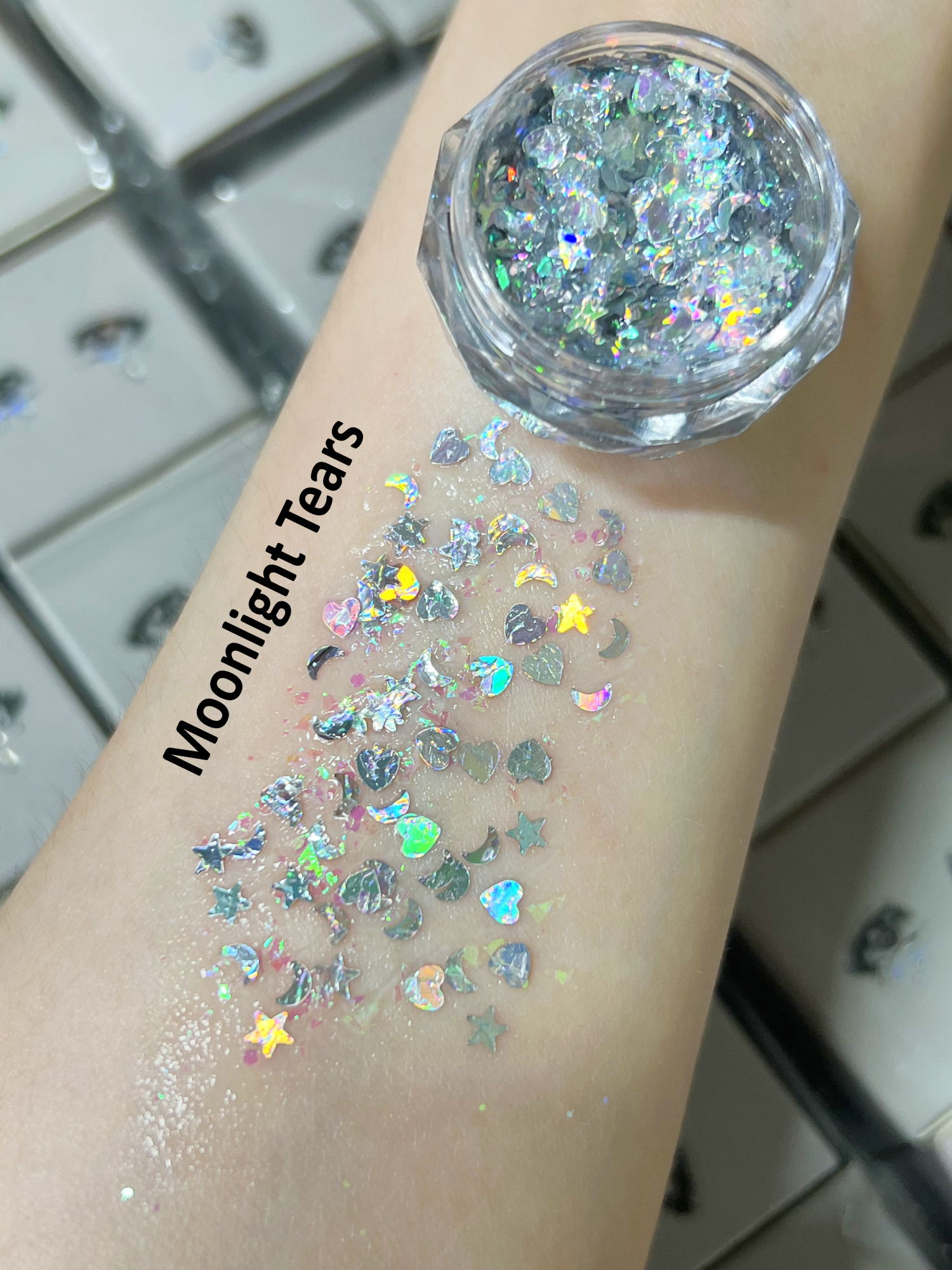 Nekoyanin Gel Glitter Tears in a clear jar with shimmering, iridescent glitter for nail art or crafts.