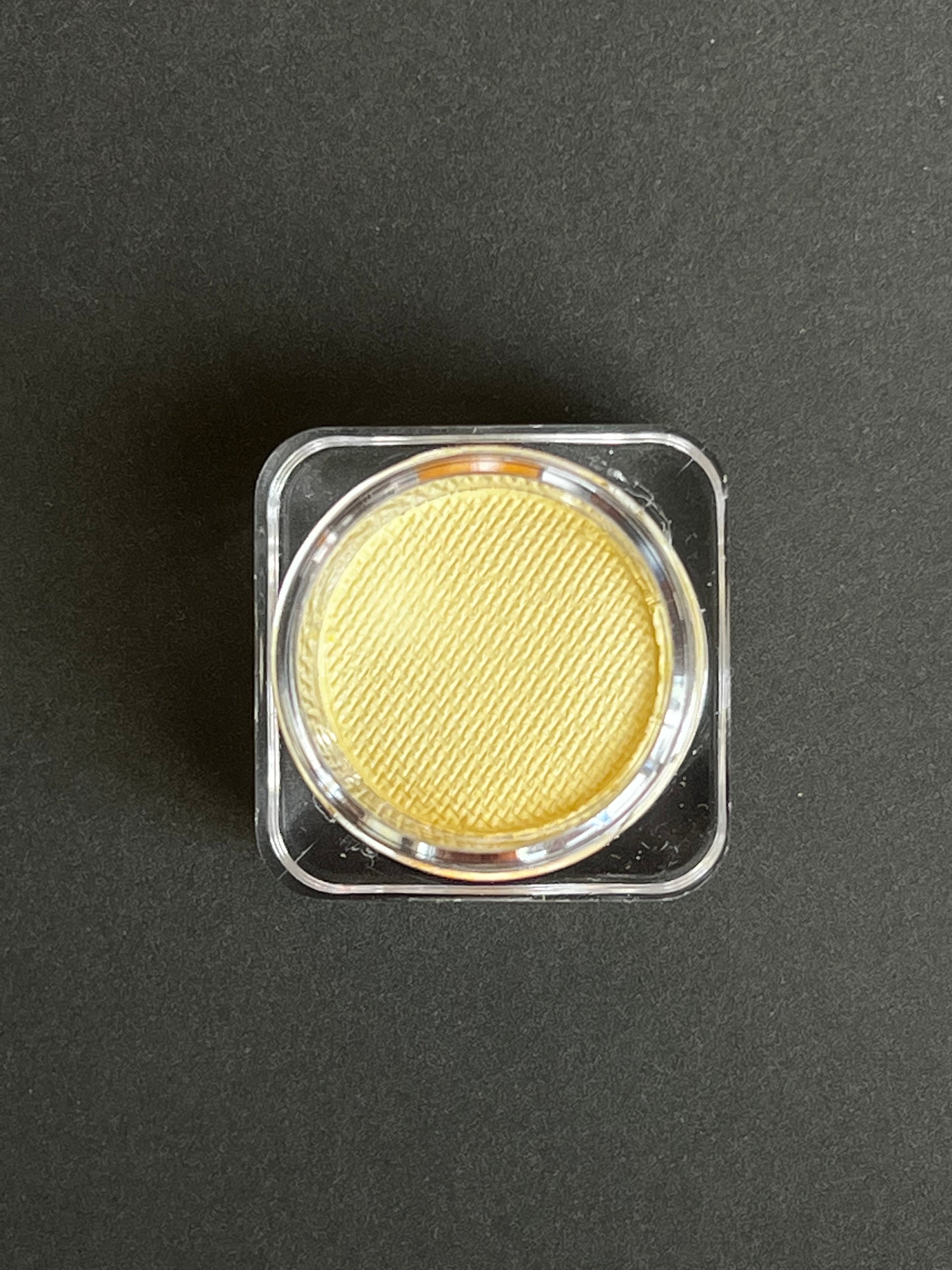 Ivory beige water-activated graphic liner by Nekoyanin, shown with its sleek packaging and detailed applicator.