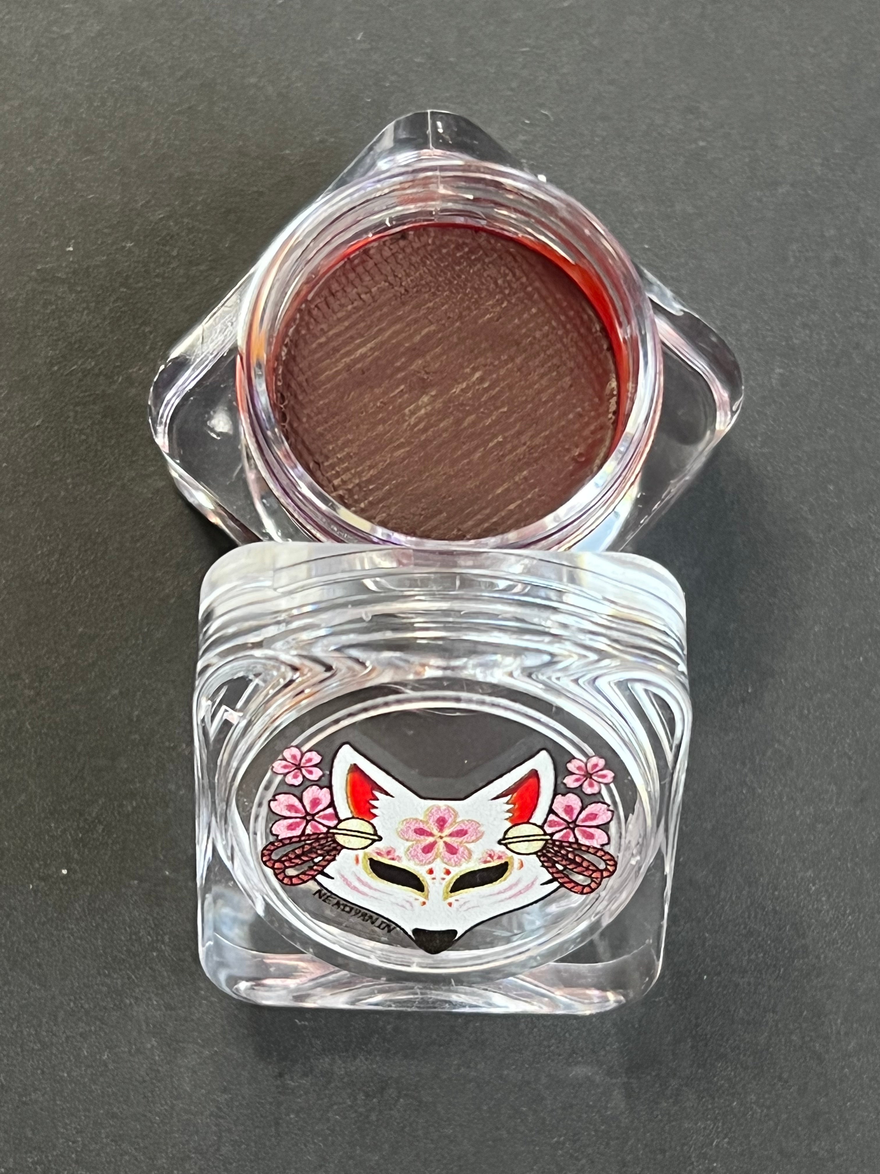 Nekoyanin 10 Auburn brown water-activated graphic eyeliner, close-up of the brown eyeliner pencil with a textured cap and branding