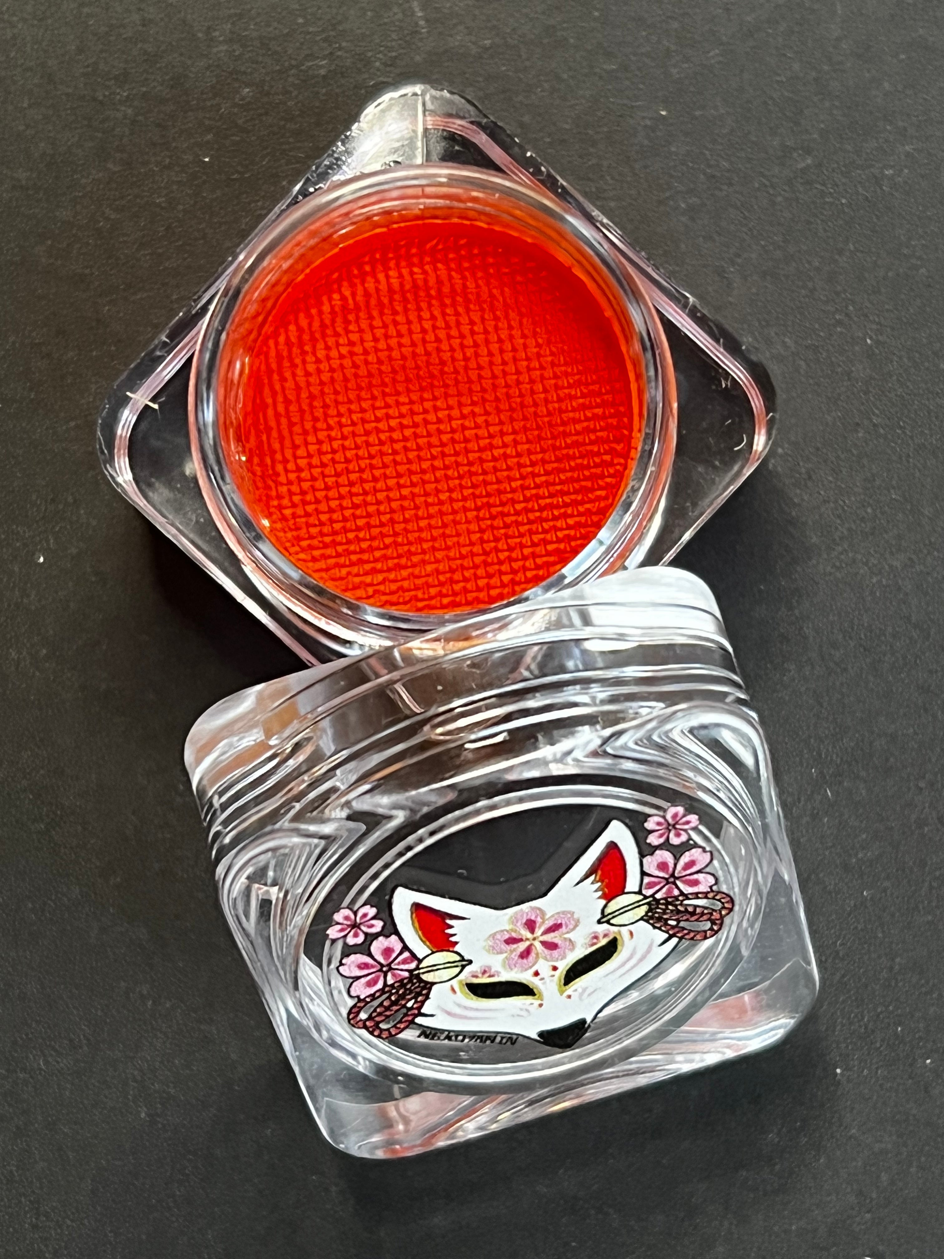 Nekoyanin 12 Apricot Orange Water Activated Graphic Liner, vibrant liquid eyeliner with orange shade and artistic design.