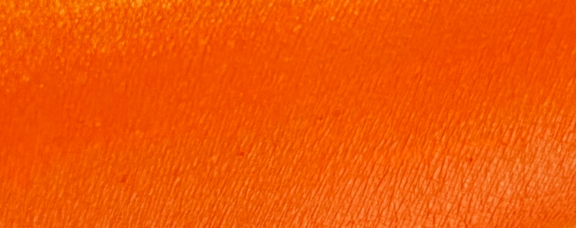 Nekoyanin water-activated graphic liner in vibrant apricot orange, shown in a sleek tube with the open cap revealing the liner.