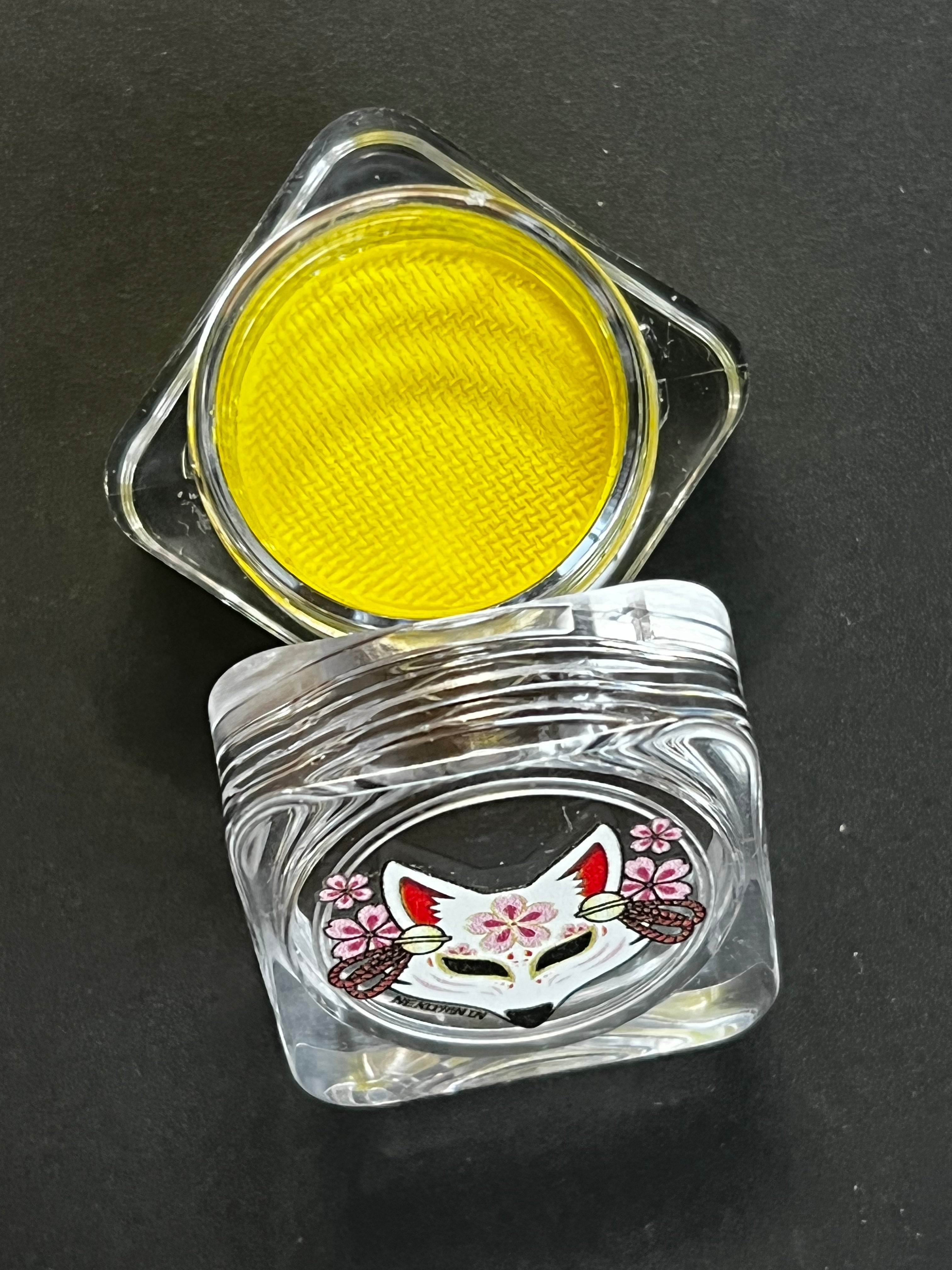 Nekoyanin 13 Aureolin shiny yellow water-activated graphic eyeliner, displayed with the product tube and applicator.