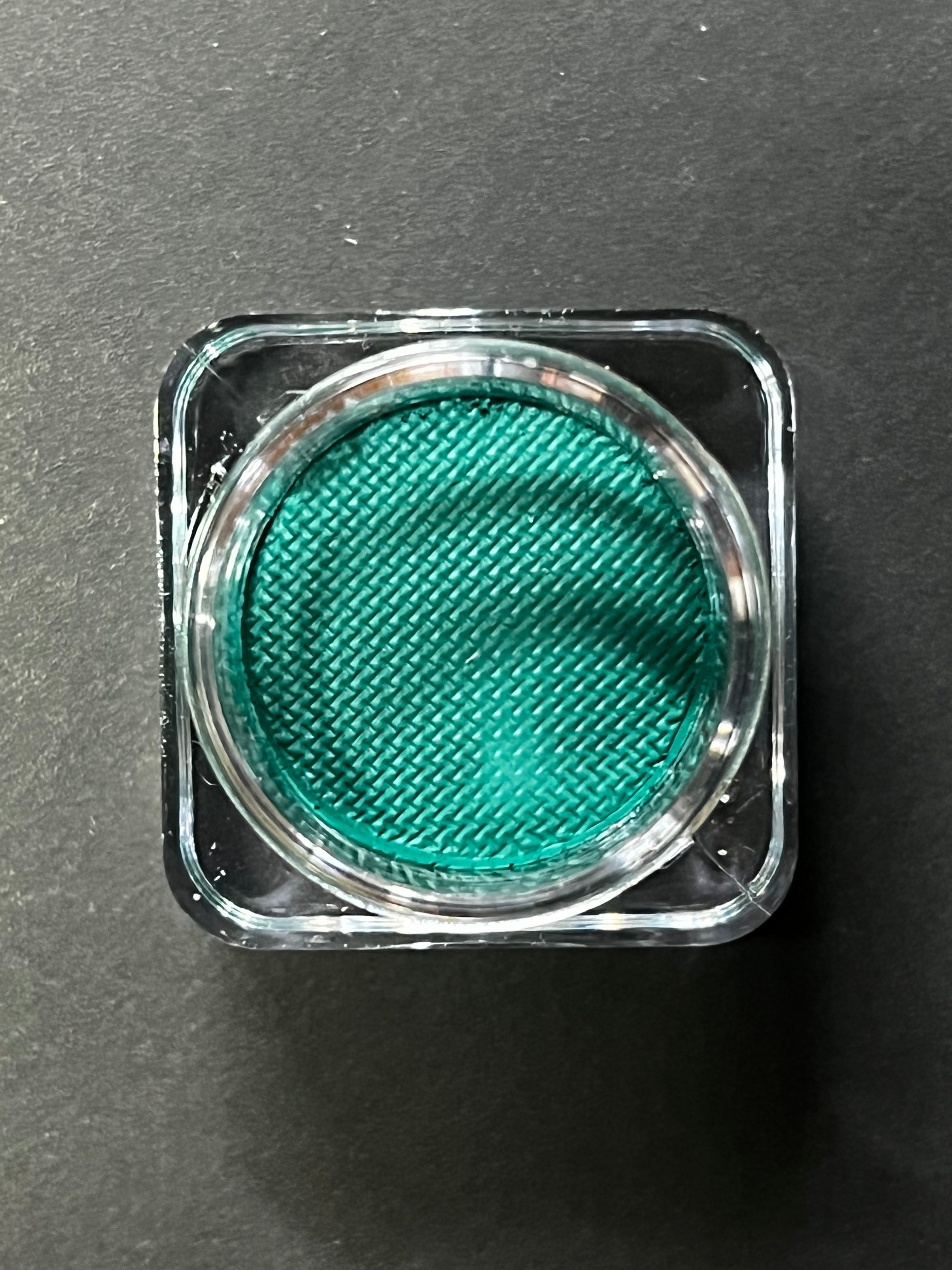 Nekoyanin Aqua Water Activated Graphic Liner in vibrant turquoise, showcasing its water-activated ink and bold design.