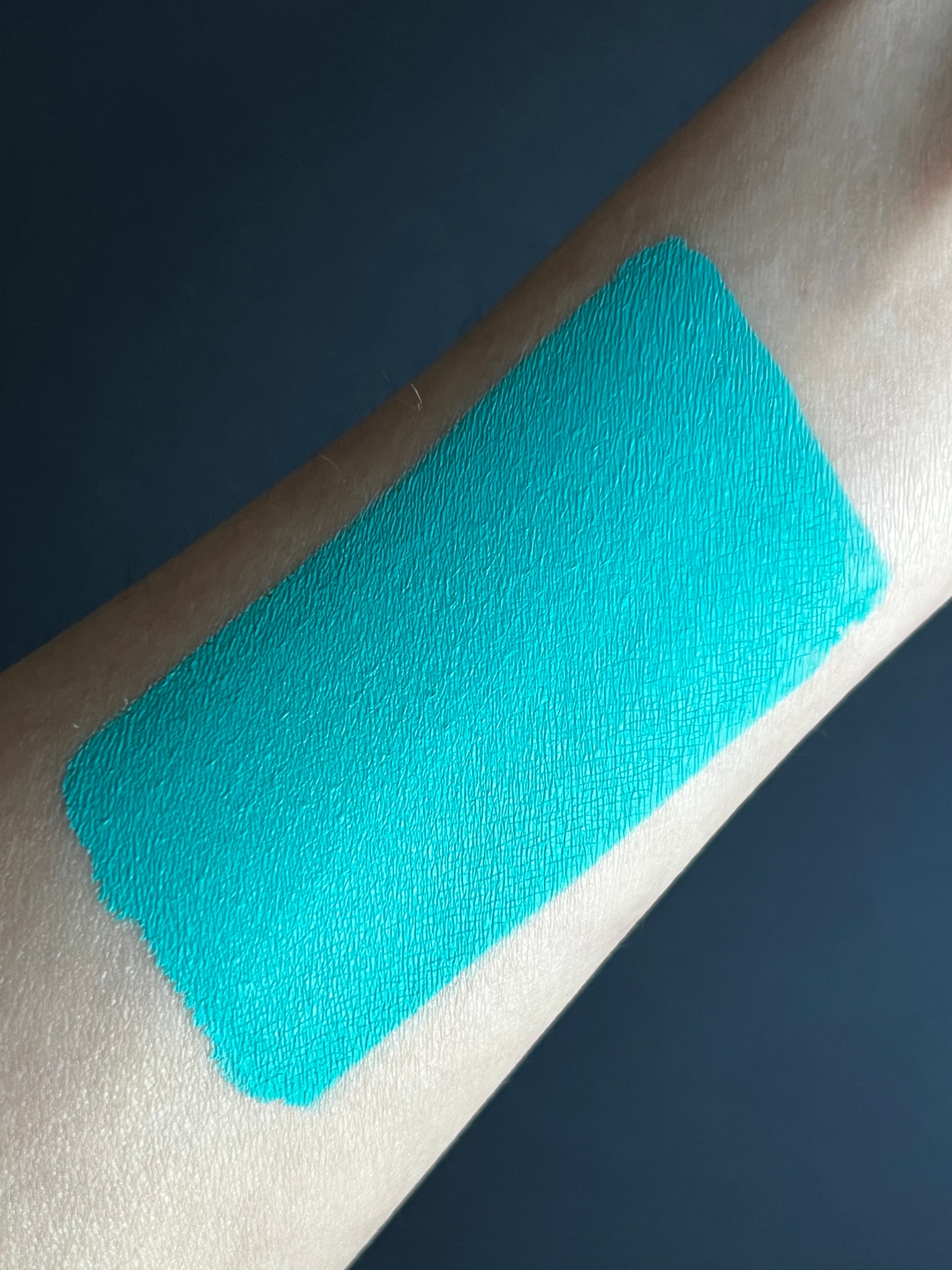 Nekoyanin 23 Cyan blue water-activated graphic liner with a vibrant, bold color and precise application visible on skin.