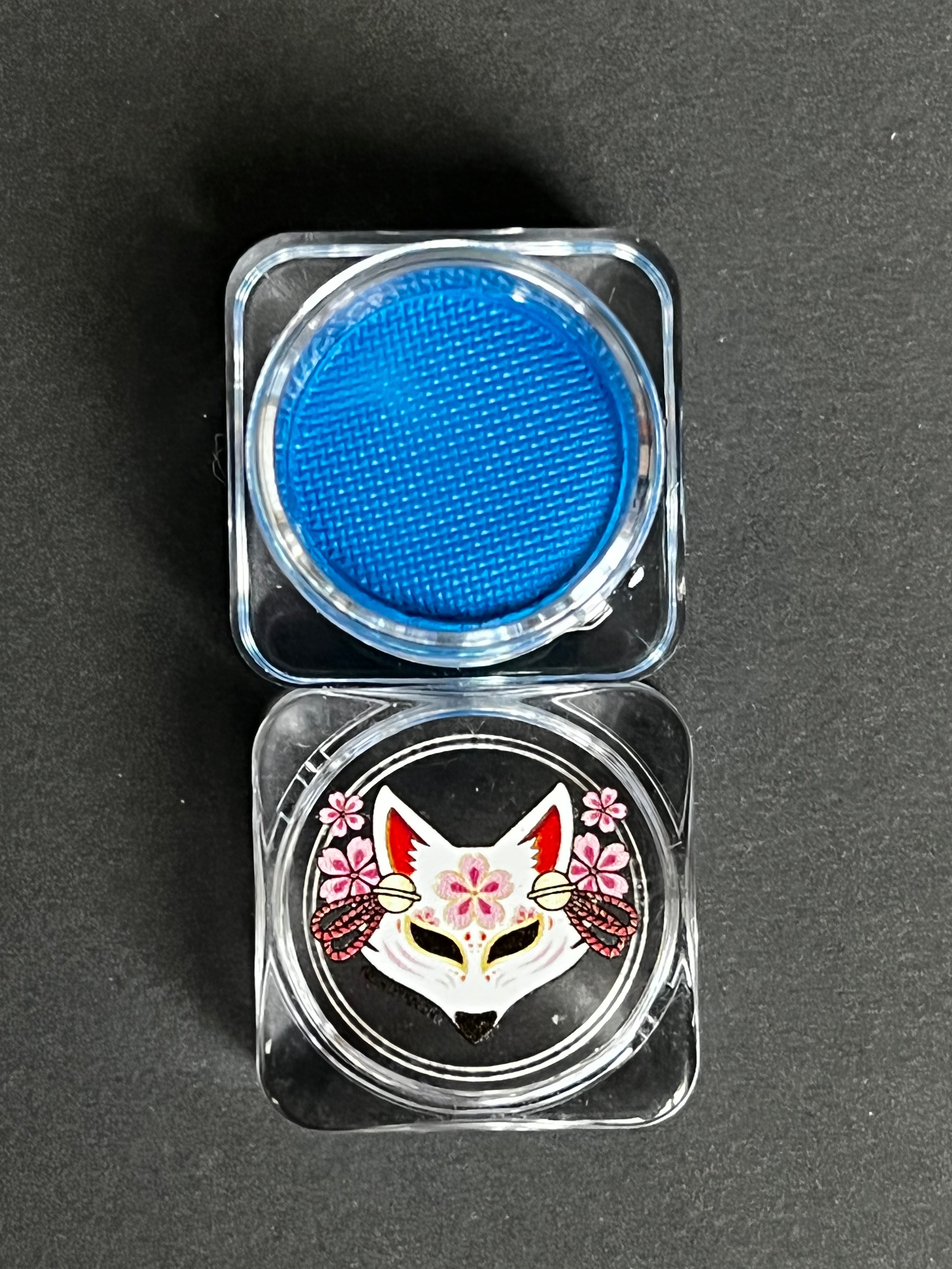 Cobalt blue water-activated graphic eyeliner by Nekoyanin, showing the vibrant, detailed design on a white background.