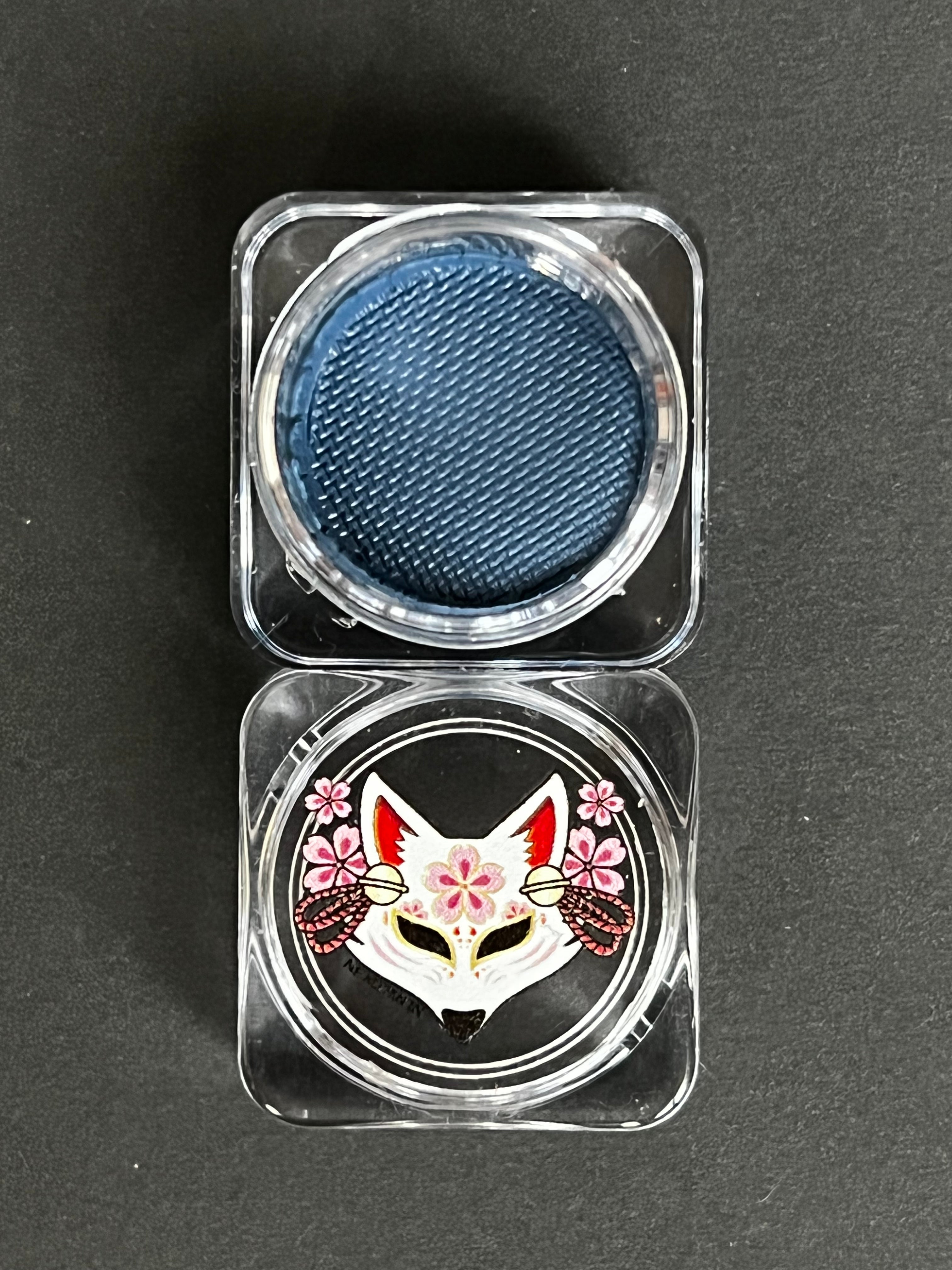 Blue denim water-activated graphic eyeliner by Nekoyanin, showing the vibrant, detailed design on the product container.
