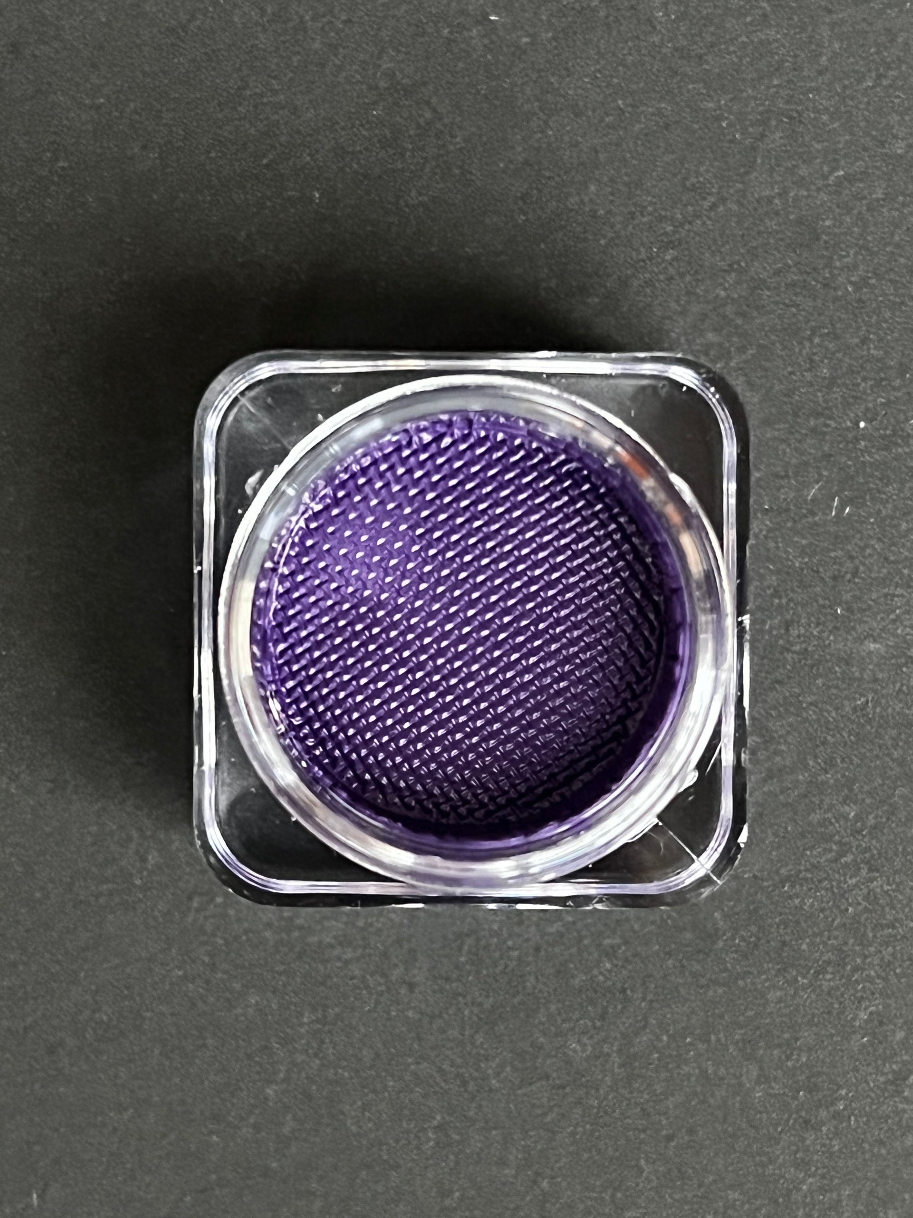 Indigo purple water-activated graphic eyeliner by Nekoyanin, showing the vibrant, bold color and detailed application design.