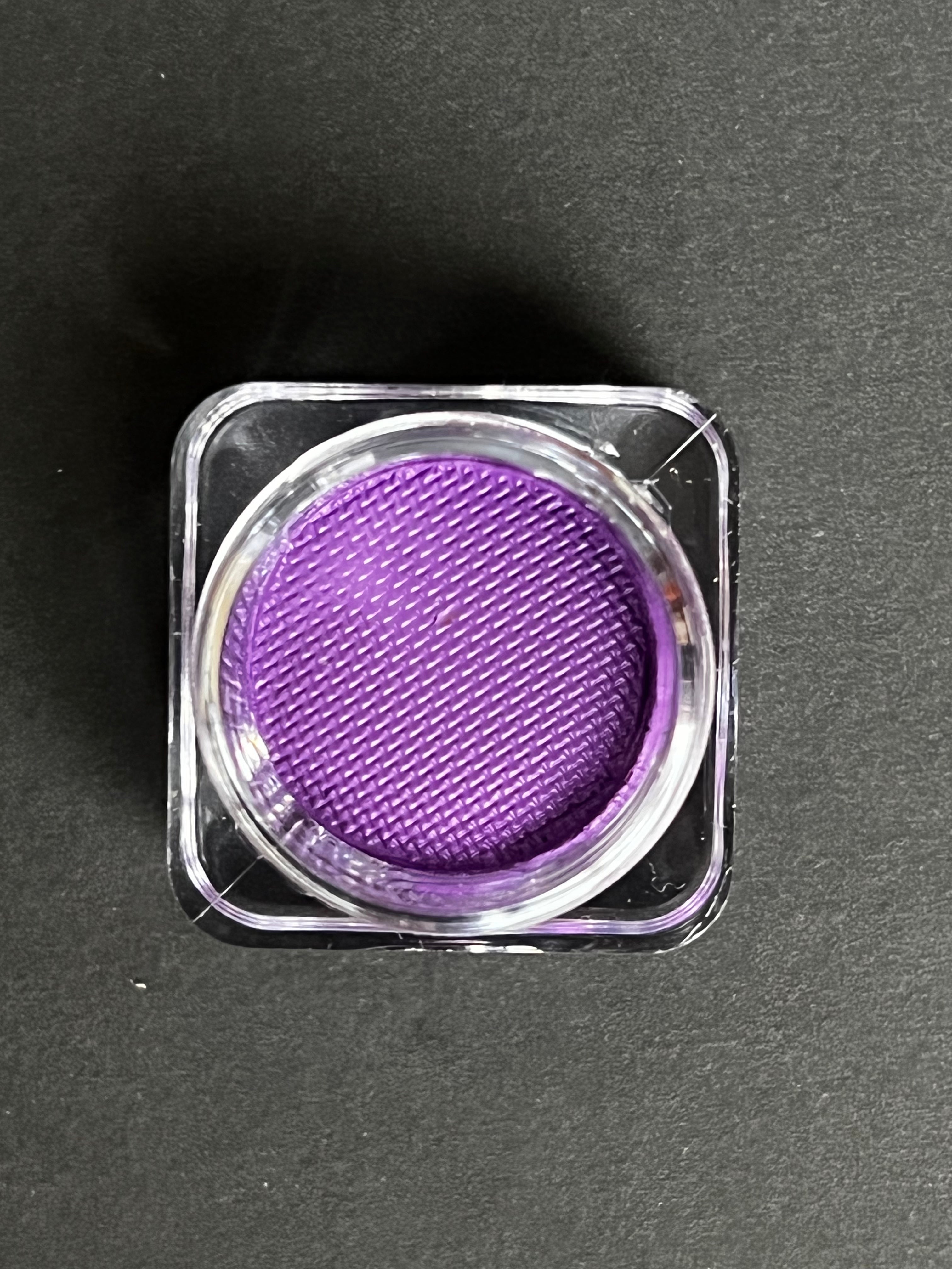 Purple Orchid Water Activated Graphic Liner by Nekoyanin, showcasing a vibrant, artistic eyeliner design on the product packaging.