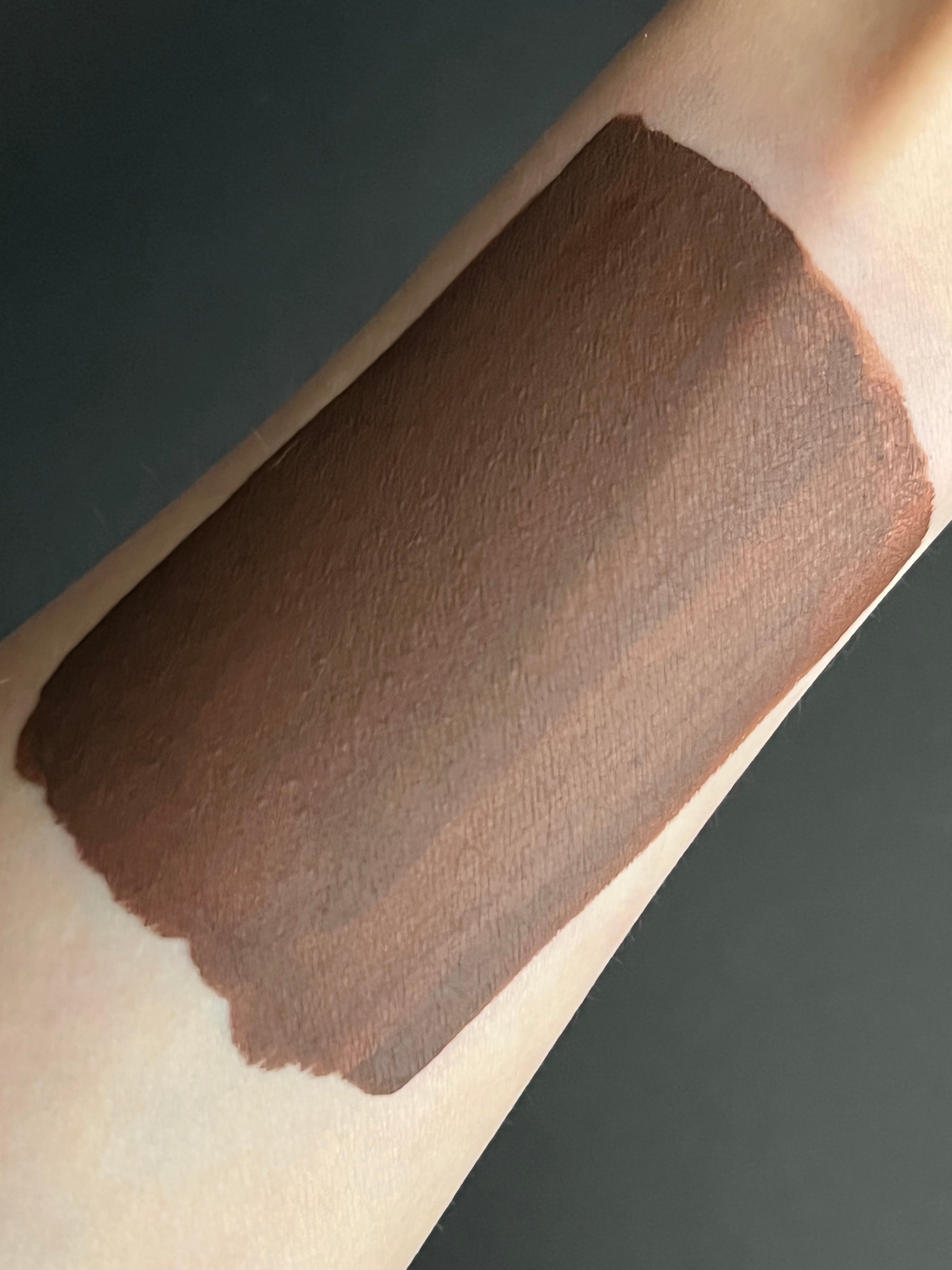 Nekoyanin Mocha brown water-activated graphic liner displayed on a makeup palette with a sleek applicator brush.