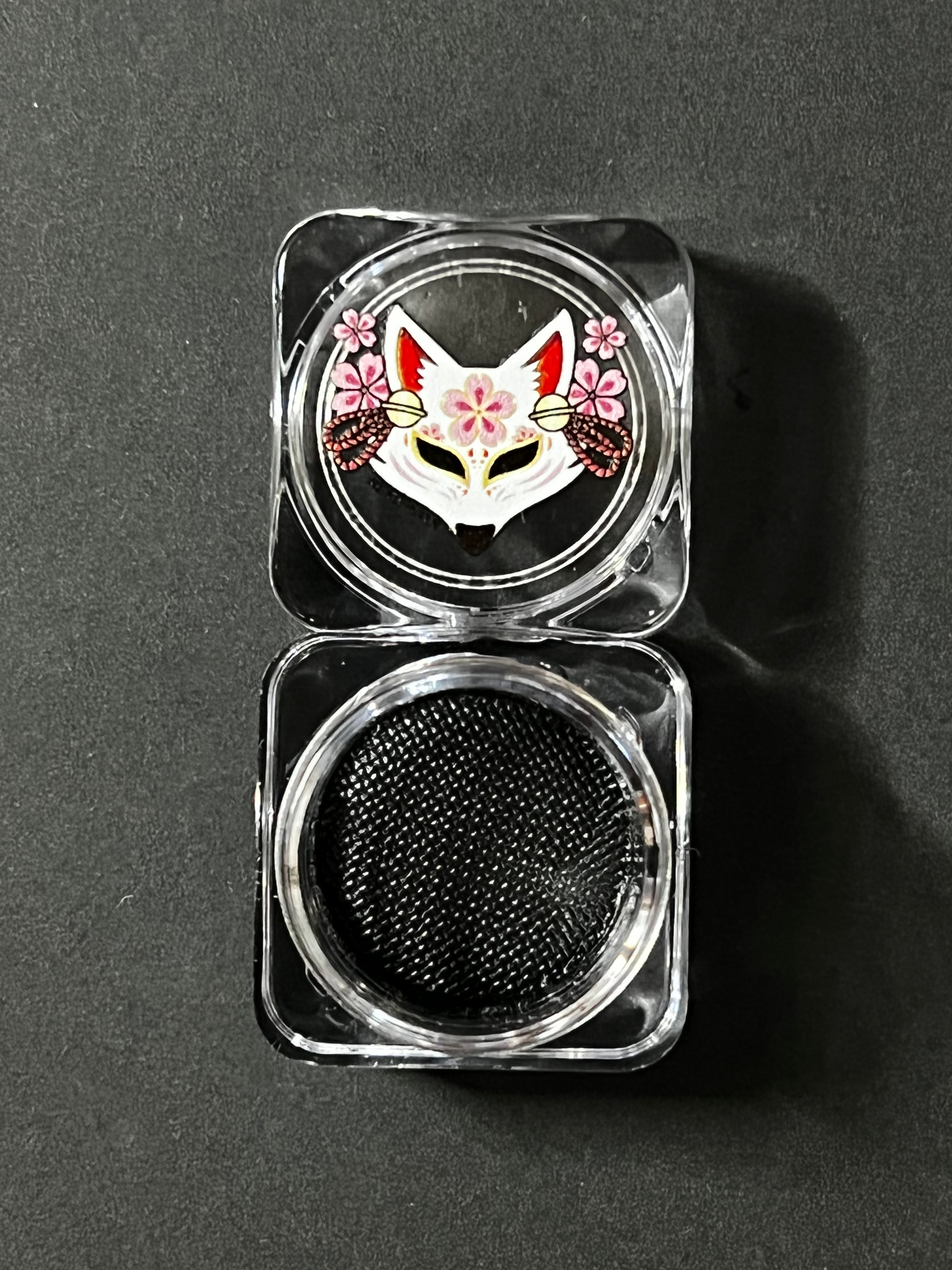 Black water-activated graphic eyeliner called Raven by Nekoyanin, featuring a sleek, bold design on the product.