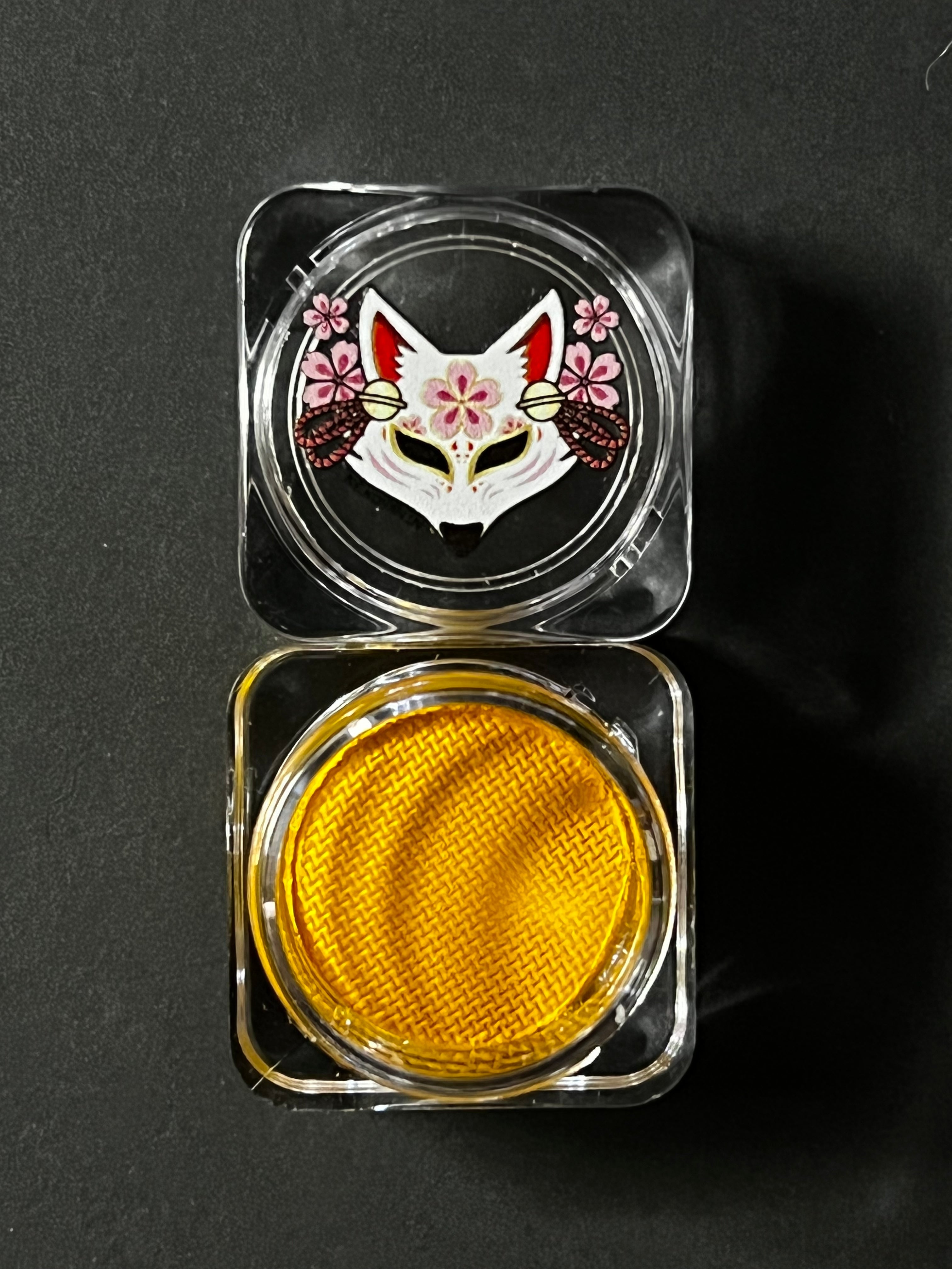 Yellow water-activated graphic eyeliner by Nekoyanin, showcasing a vivid, artistic design with a sleek liner brush.