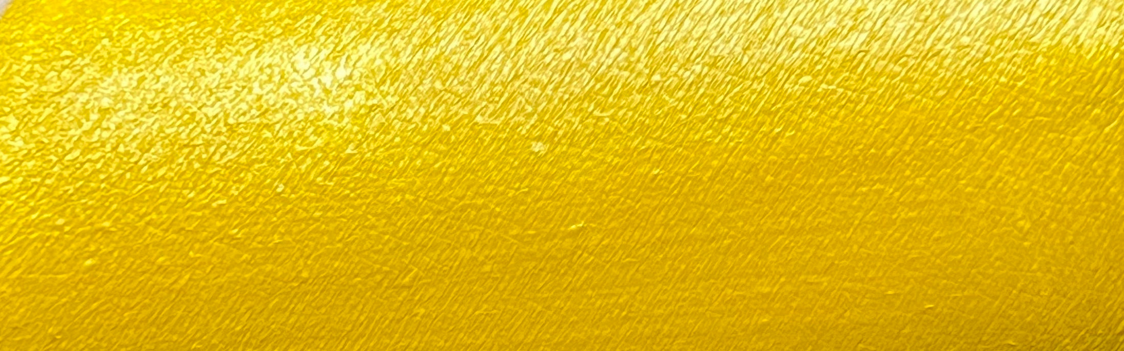 Yellow water-activated graphic liner from Nekoyanin, featuring vibrant cadmium color and precise application on a clean background.