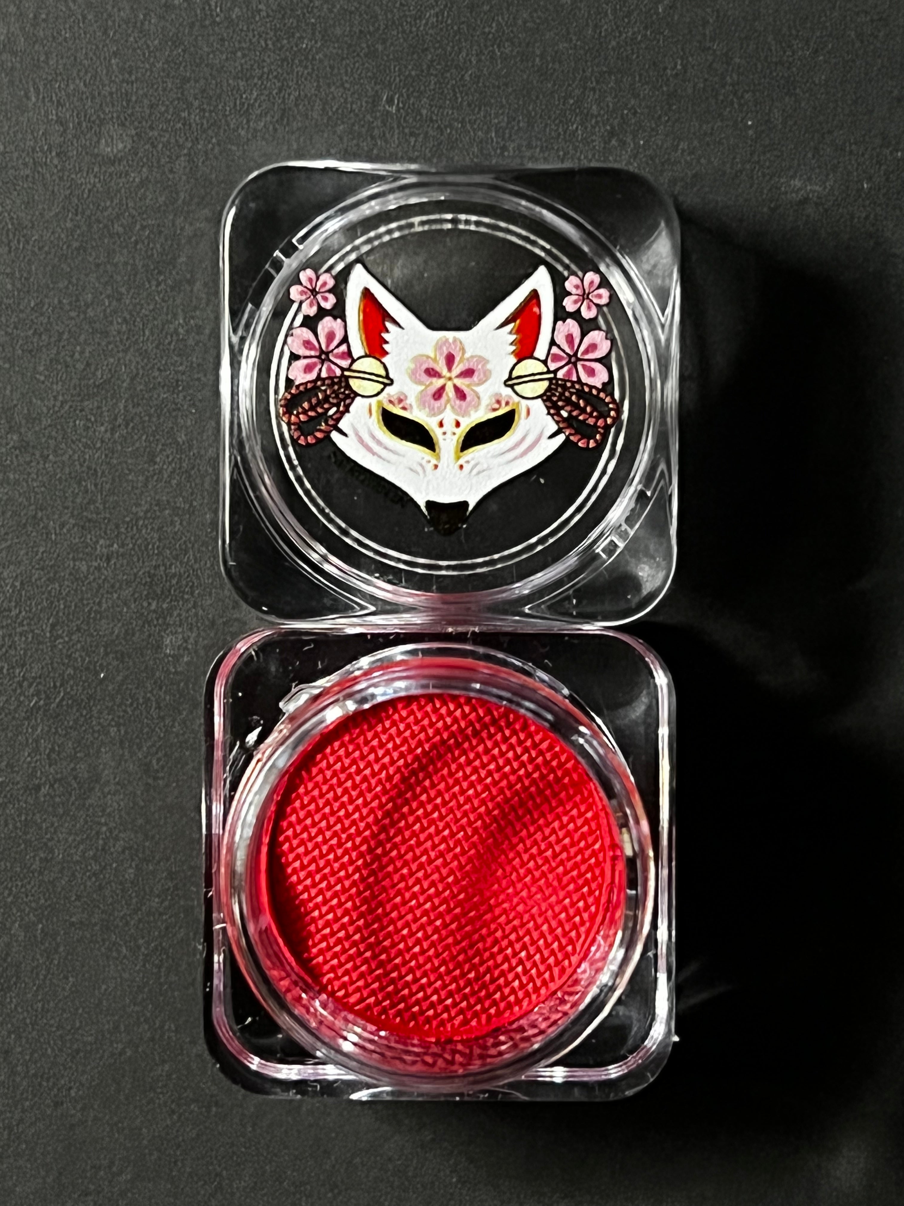 Nekoyanin Crimson Water Activated Graphic Liner in vibrant red, with a sleek pen design and detailed packaging.