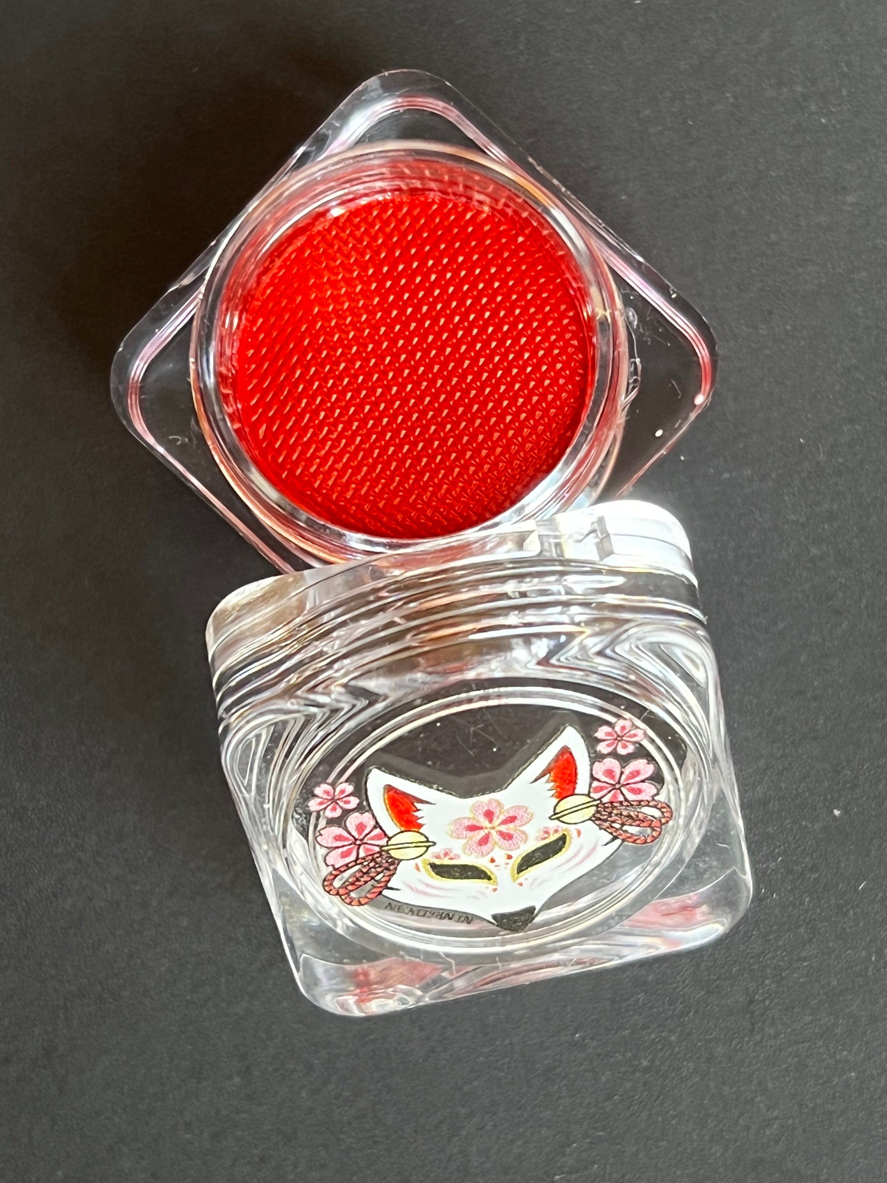 Nekoyanin Scarlet Red Water Activated Graphic Liner displayed with vibrant red color and sleek design for eye makeup.