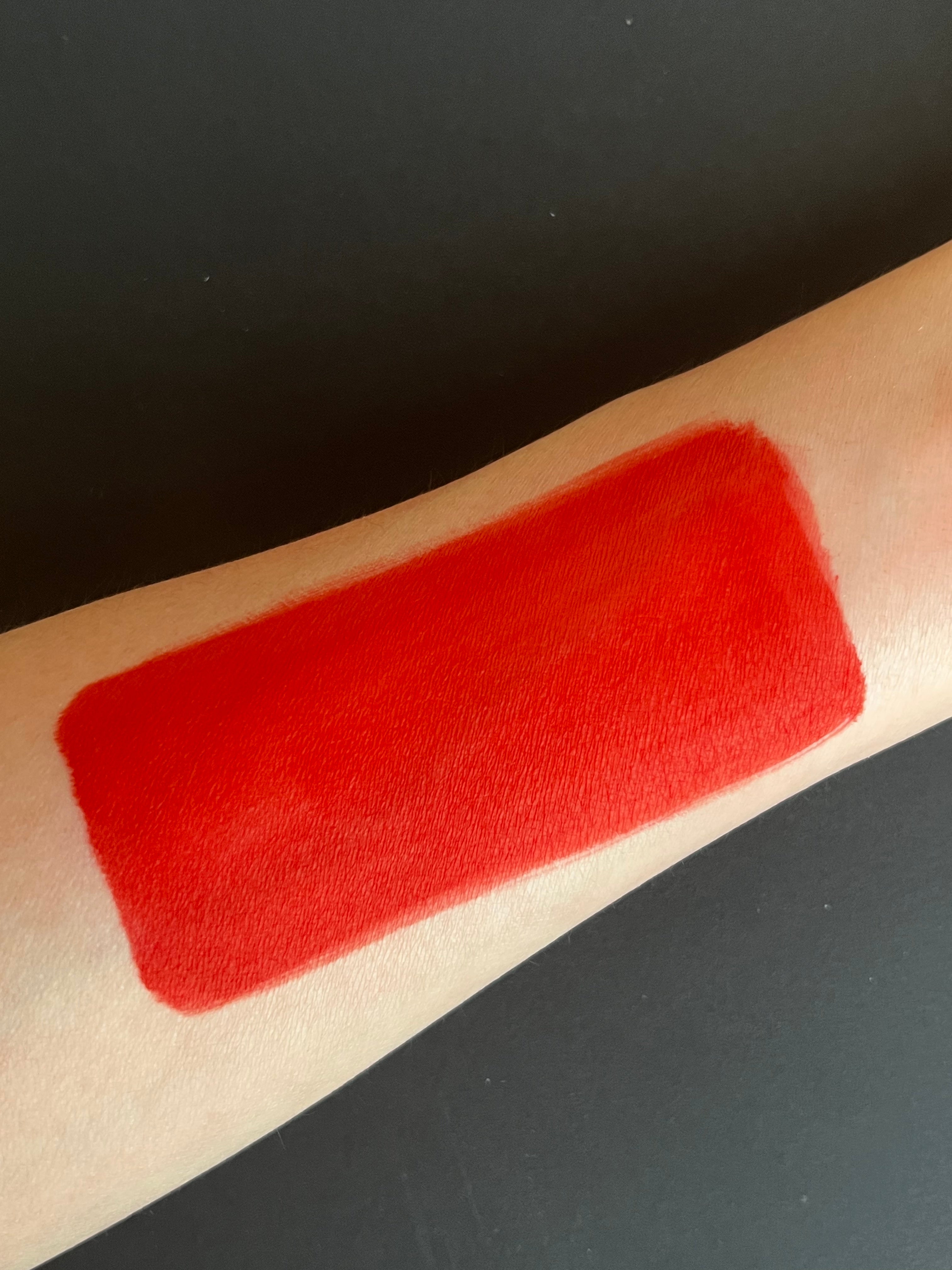 Red water-activated graphic eyeliner featuring apple design by Nekoyanin, shown in a close-up image.
