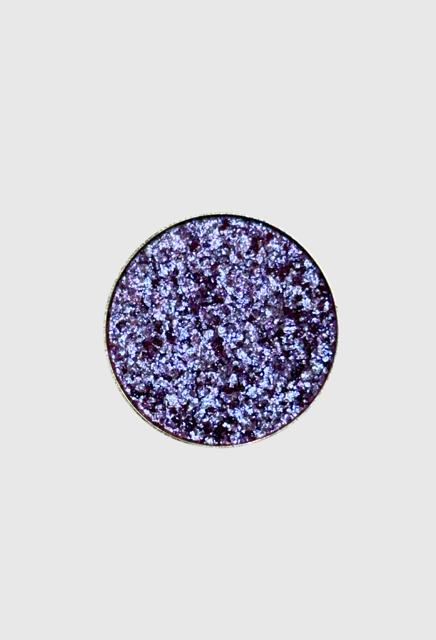 Nekoyanin Enchanted pressed pigment eyeshadow in a vibrant, shimmering shade with a textured, colorful pressed powder appearance.