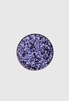 Nekoyanin Enchanted pressed pigment eyeshadow in a vibrant, shimmering shade with a textured, colorful pressed powder appearance.