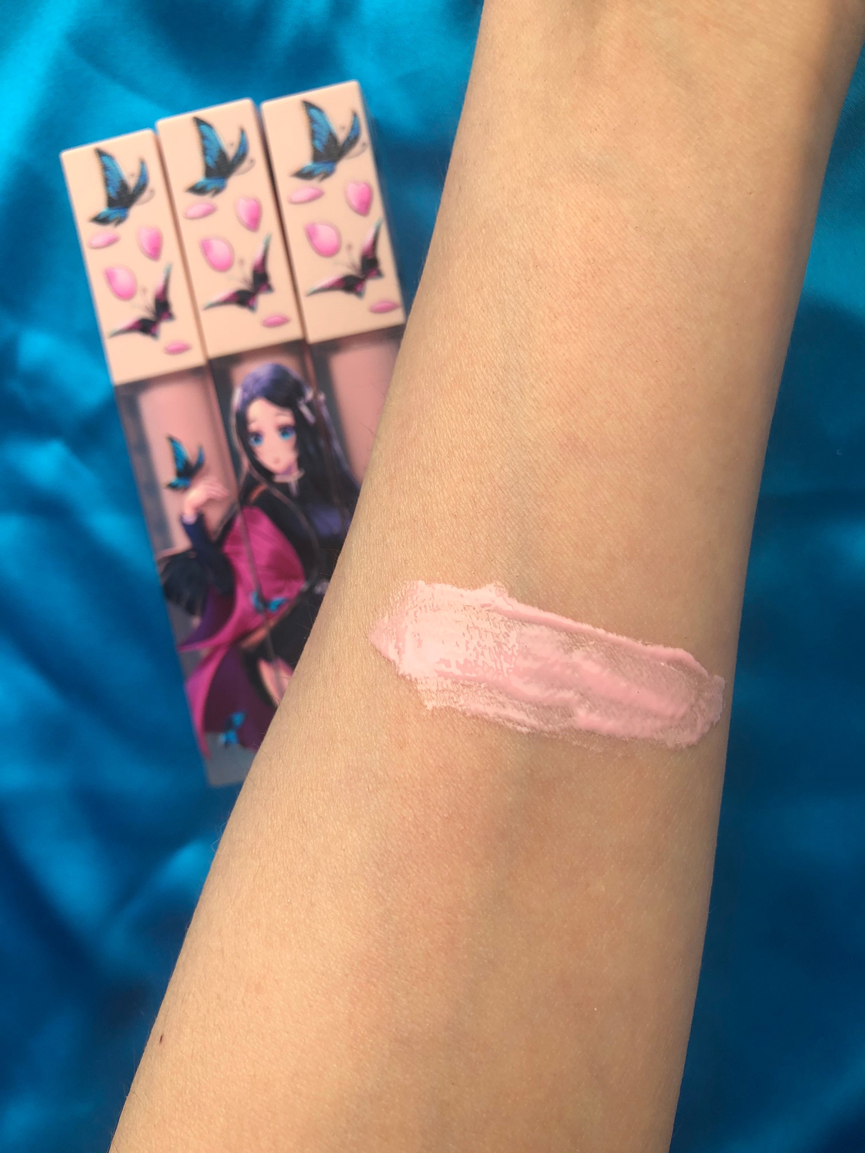 Nezuko Cherry Blossom Lipgloss by Nekoyanin featuring a clear tube with pink tinted gloss and cherry blossom design.
