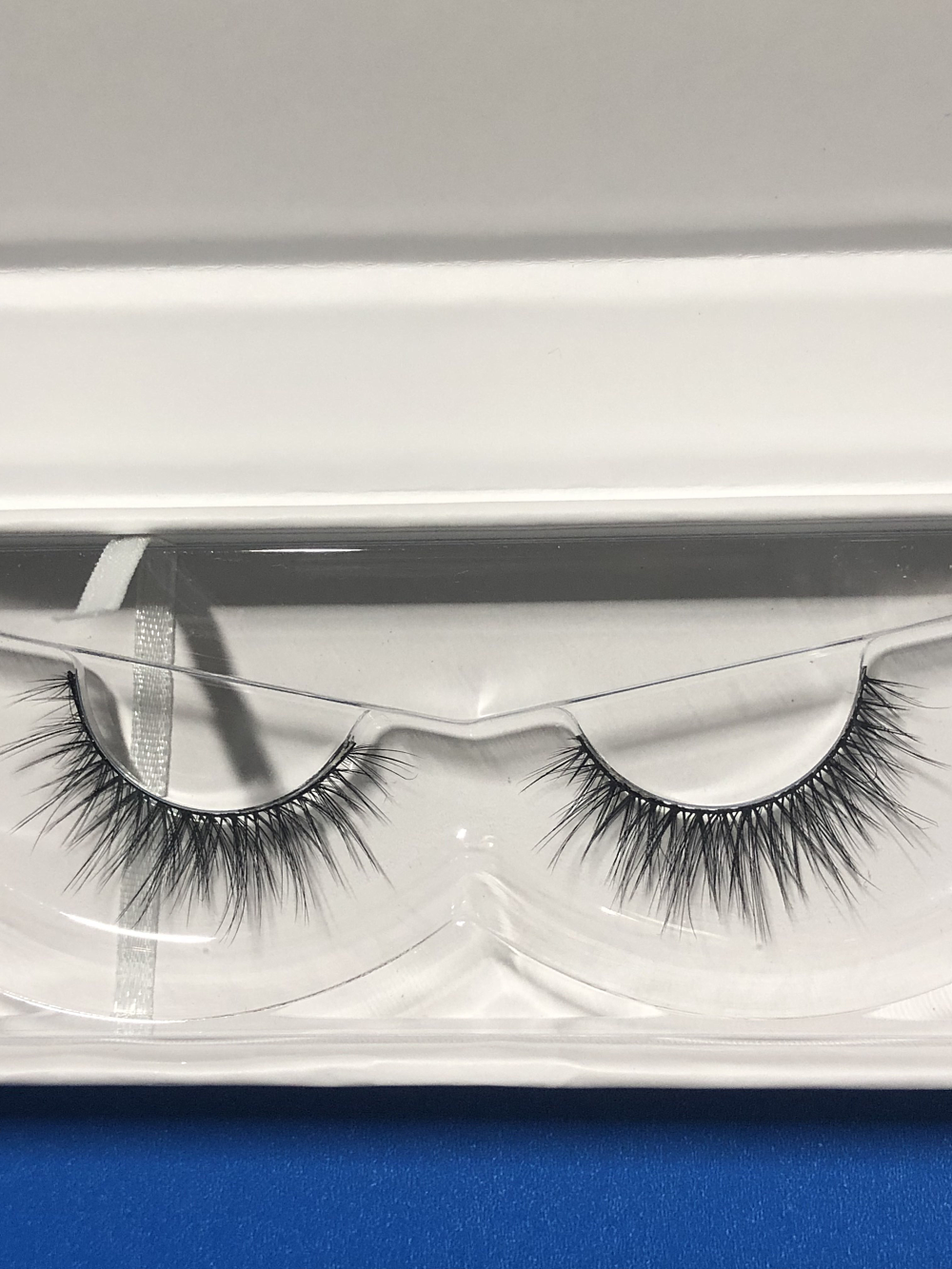 Close-up of Nekoyanin Starry Lashes showing long, wispy black false eyelashes with star-shaped accents for a dramatic look.