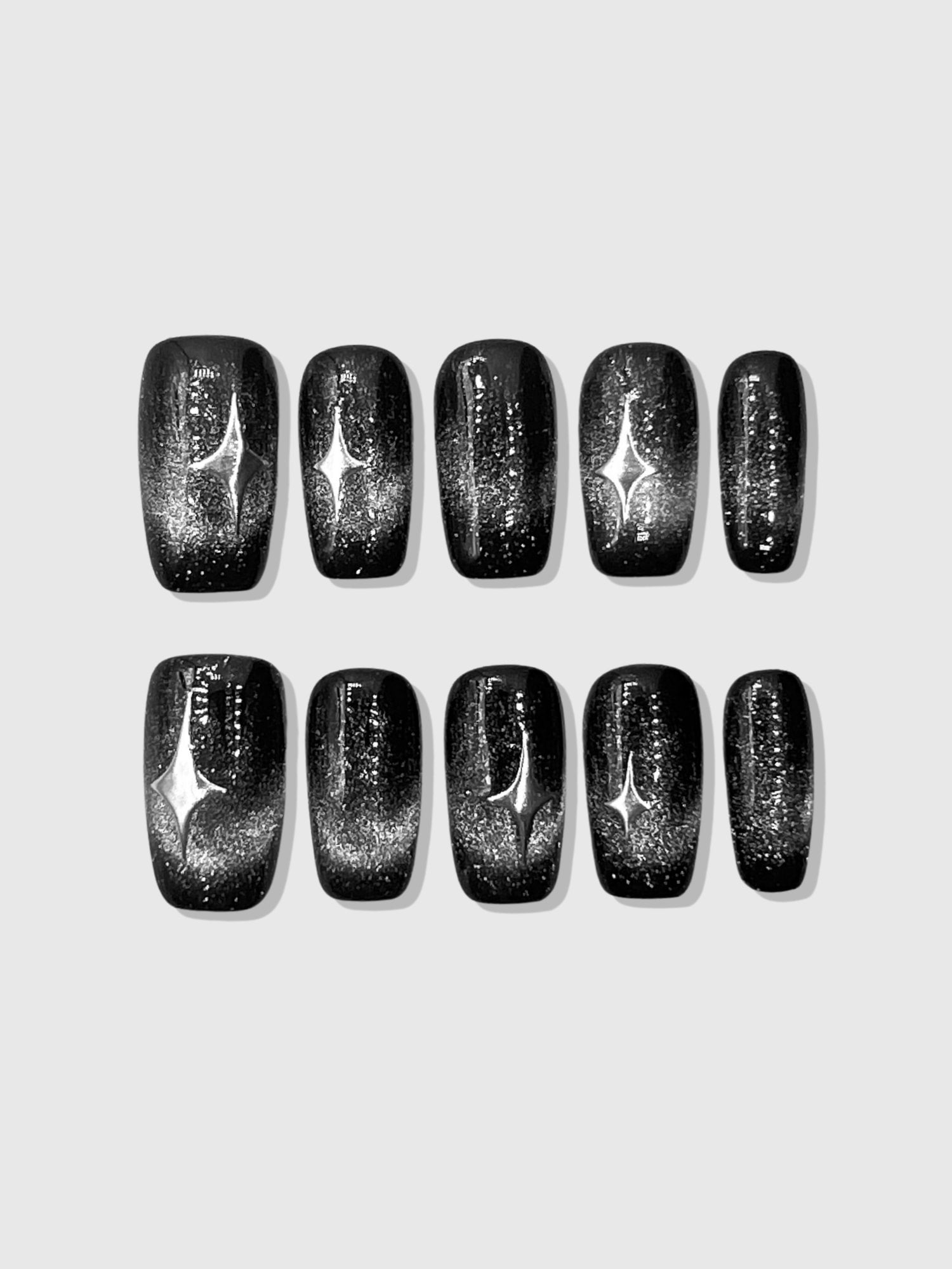 Nekoyanin Stargaze press on nails with celestial star design in a natural hand display, showcasing the nail art and length