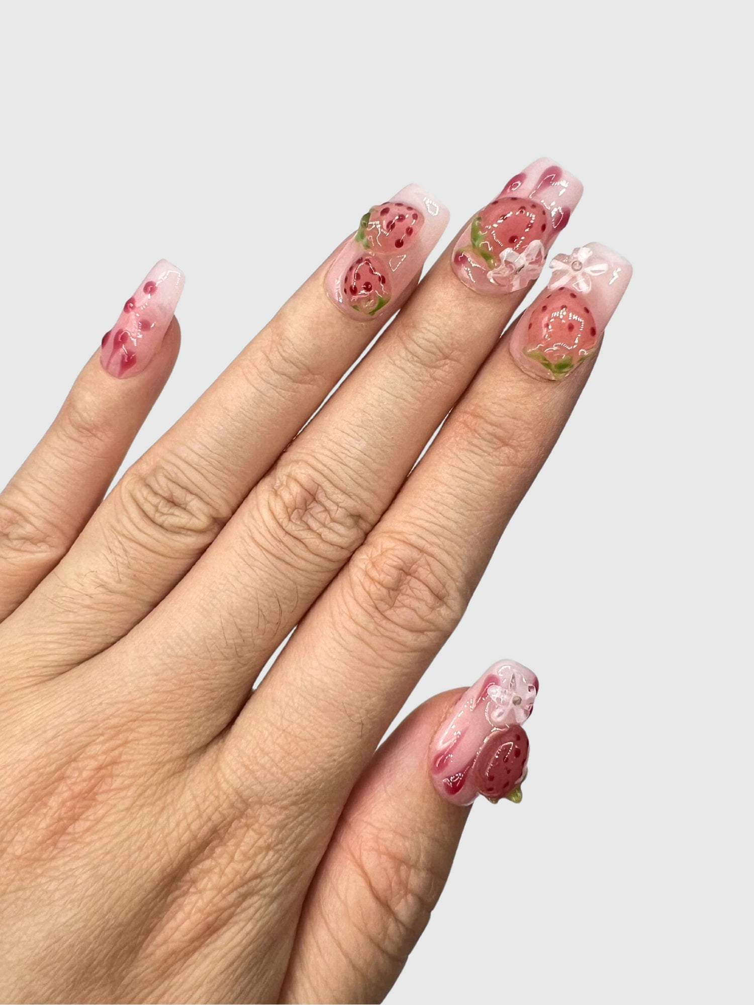 Nekoyanin Strawberry Shortcake press-on nails with pink and white design, featuring cute strawberry and shortcake motifs.