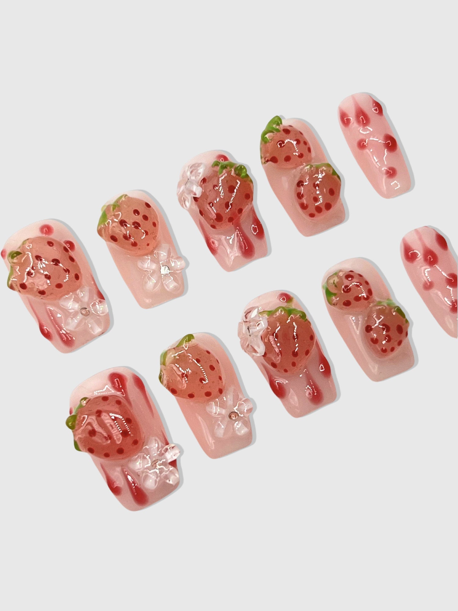 Nekoyanin strawberry shortcake press-on nails with pink and white design, perfect for a cute, quick manicure.