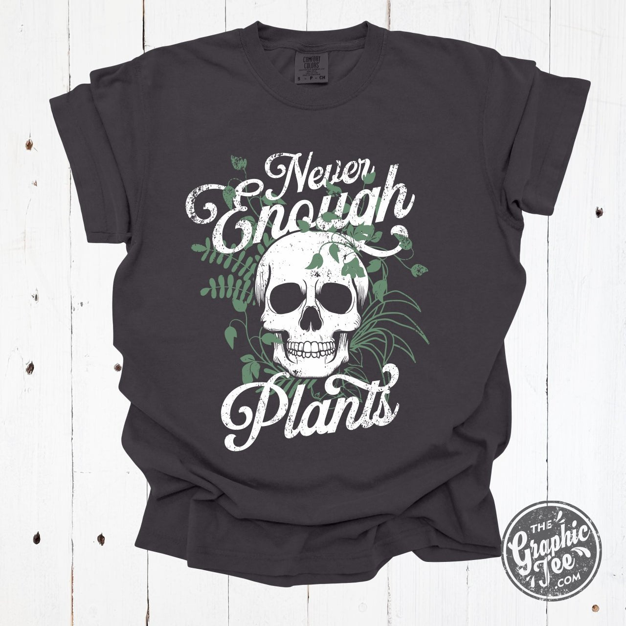 Never Enough Plants pigment dyed graphic tee by The Graphic Tee, featuring vibrant plant-inspired artwork on a casual short-sleeve shirt.