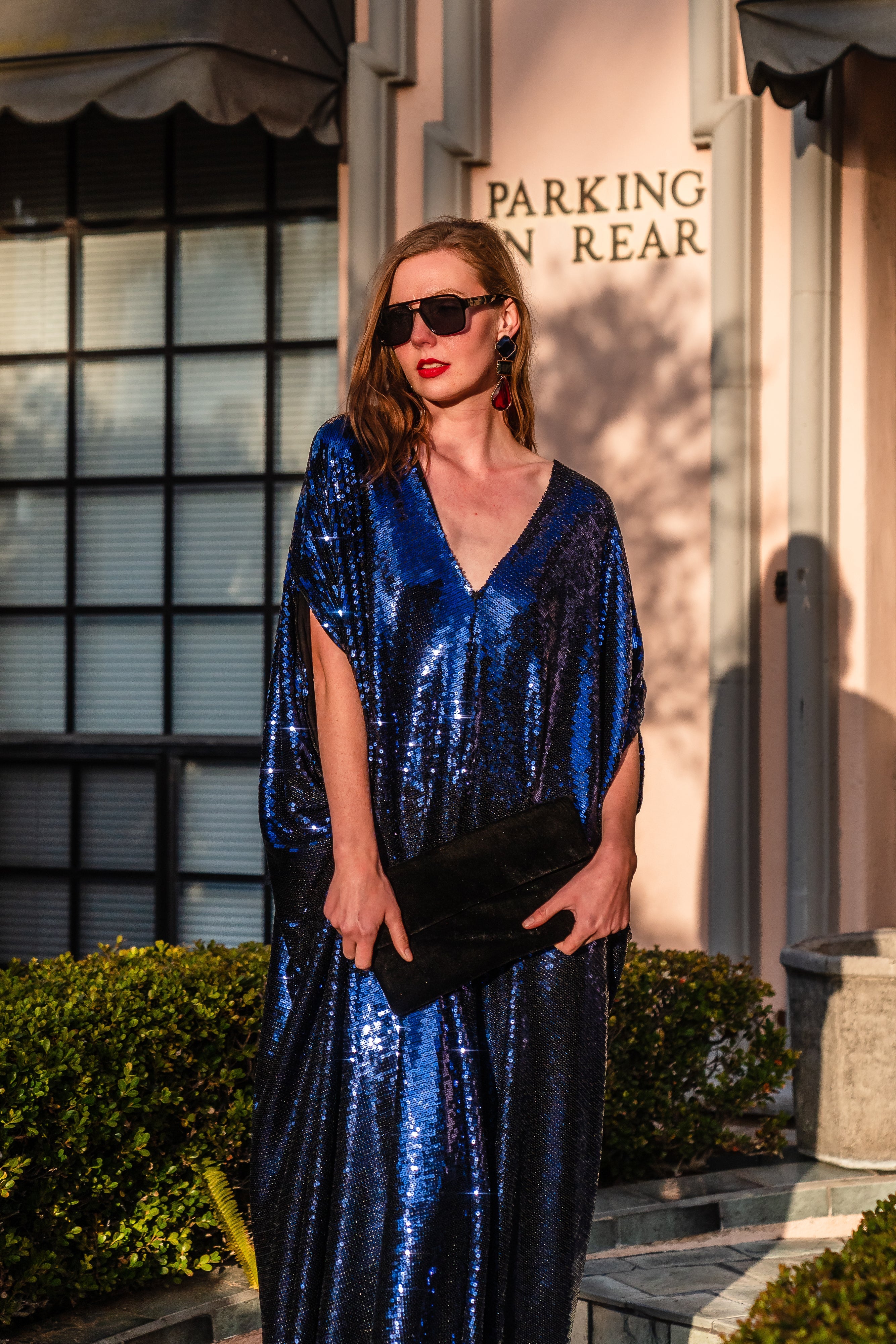 Night Sapphire sequin kaftan dress by Jennafer Grace featuring shimmering sequins and flowing fabric, shown on a hanger.